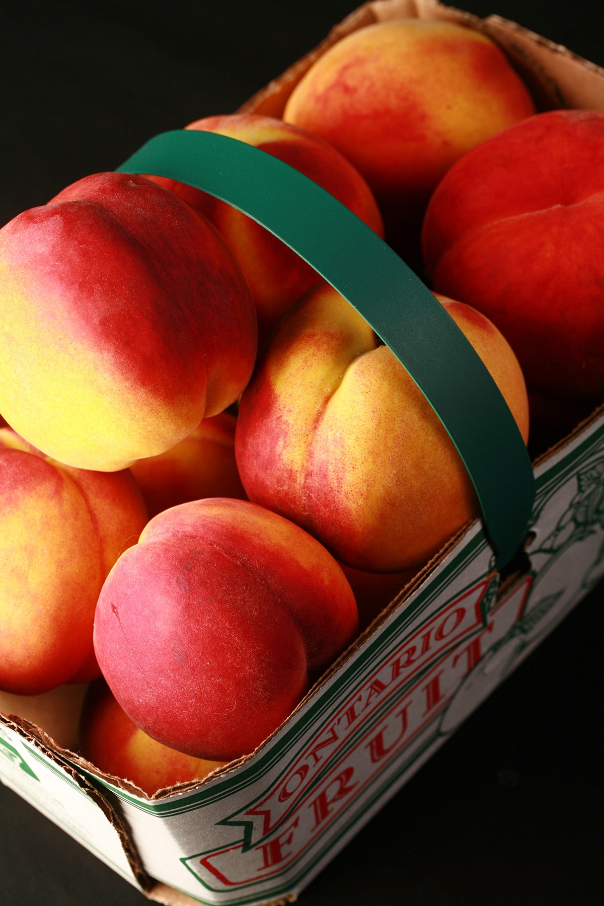 A farmer’s market basket of fresh Ontario peaches.