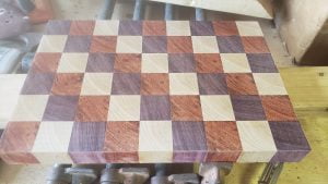 The cutting board, made from an array of small cubes, is seen face up. The surface is smooth but slightly hazy from the rough sanding.