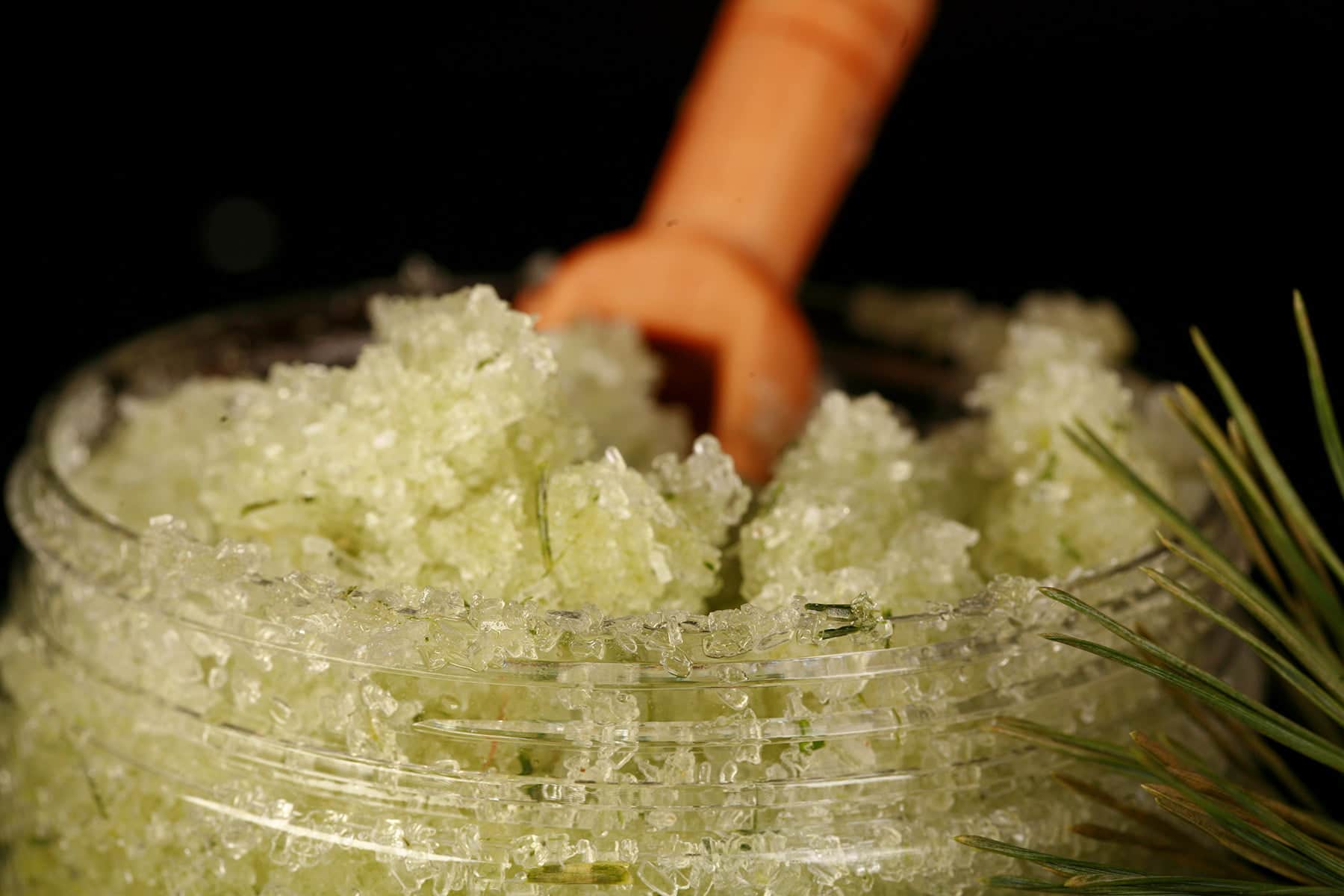 A small jar of green coloured salt scrub.