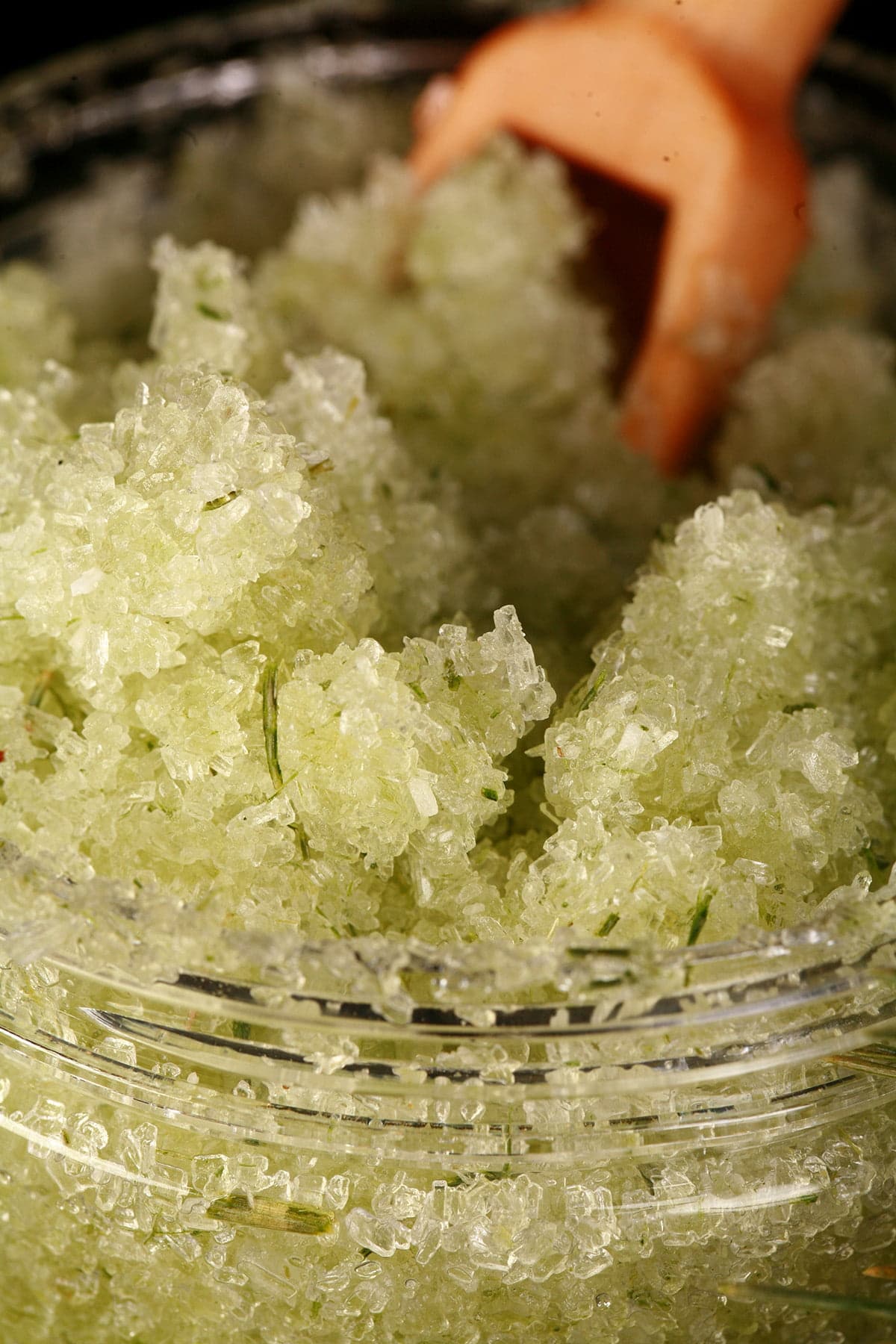 A small jar of green coloured salt scrub.