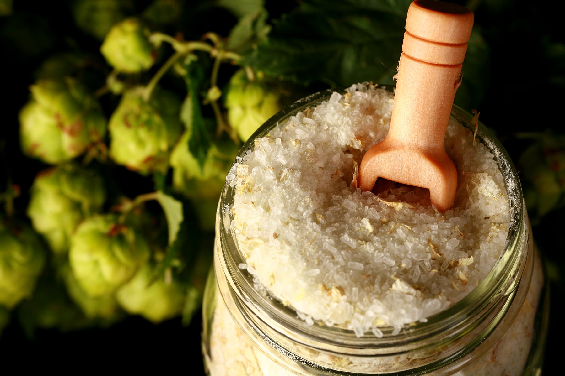 A close up view of a jar of hopped bath salt.