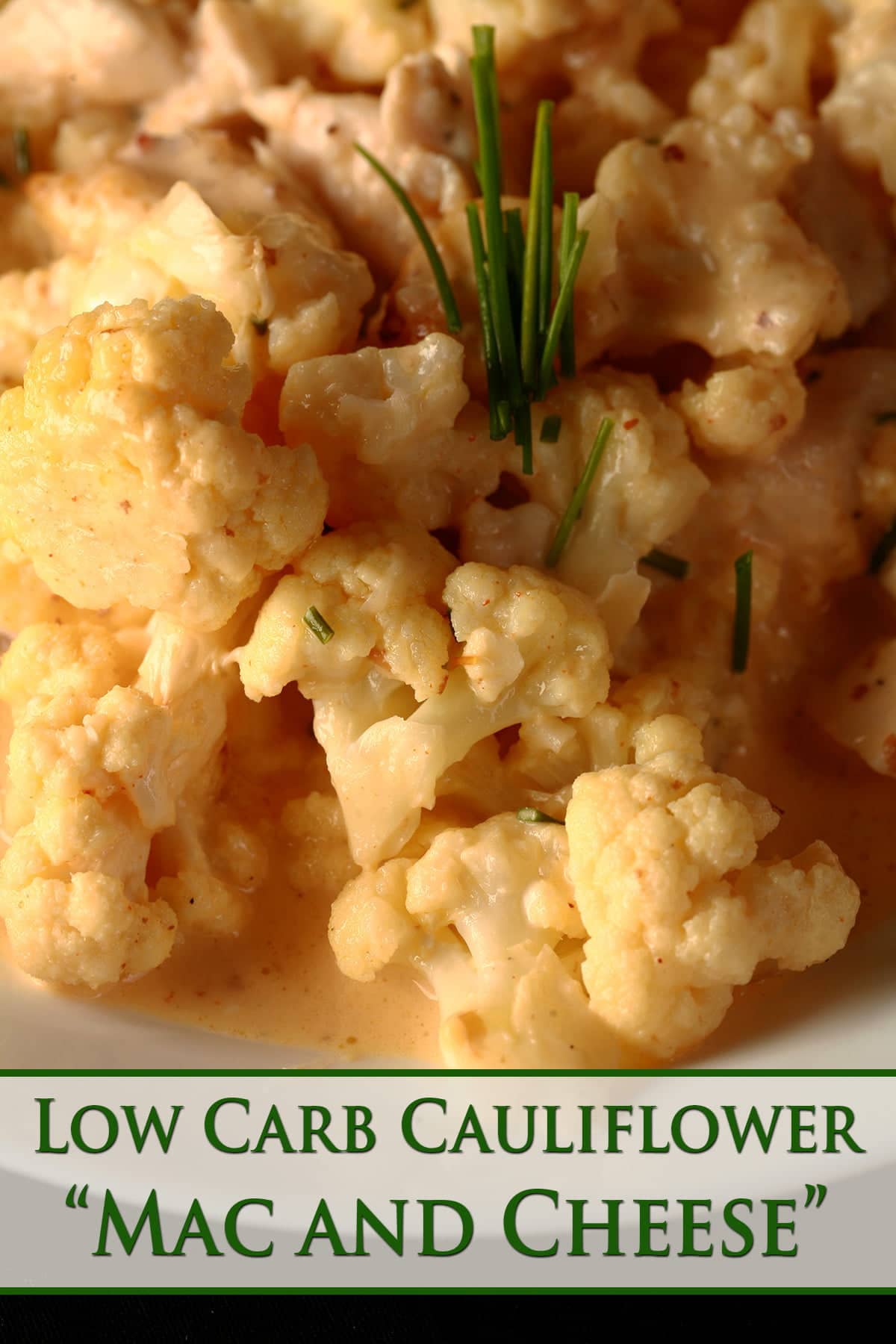 Close up view of a bowl of small pieces of cauliflower, coated in a creamy cheese sauce.