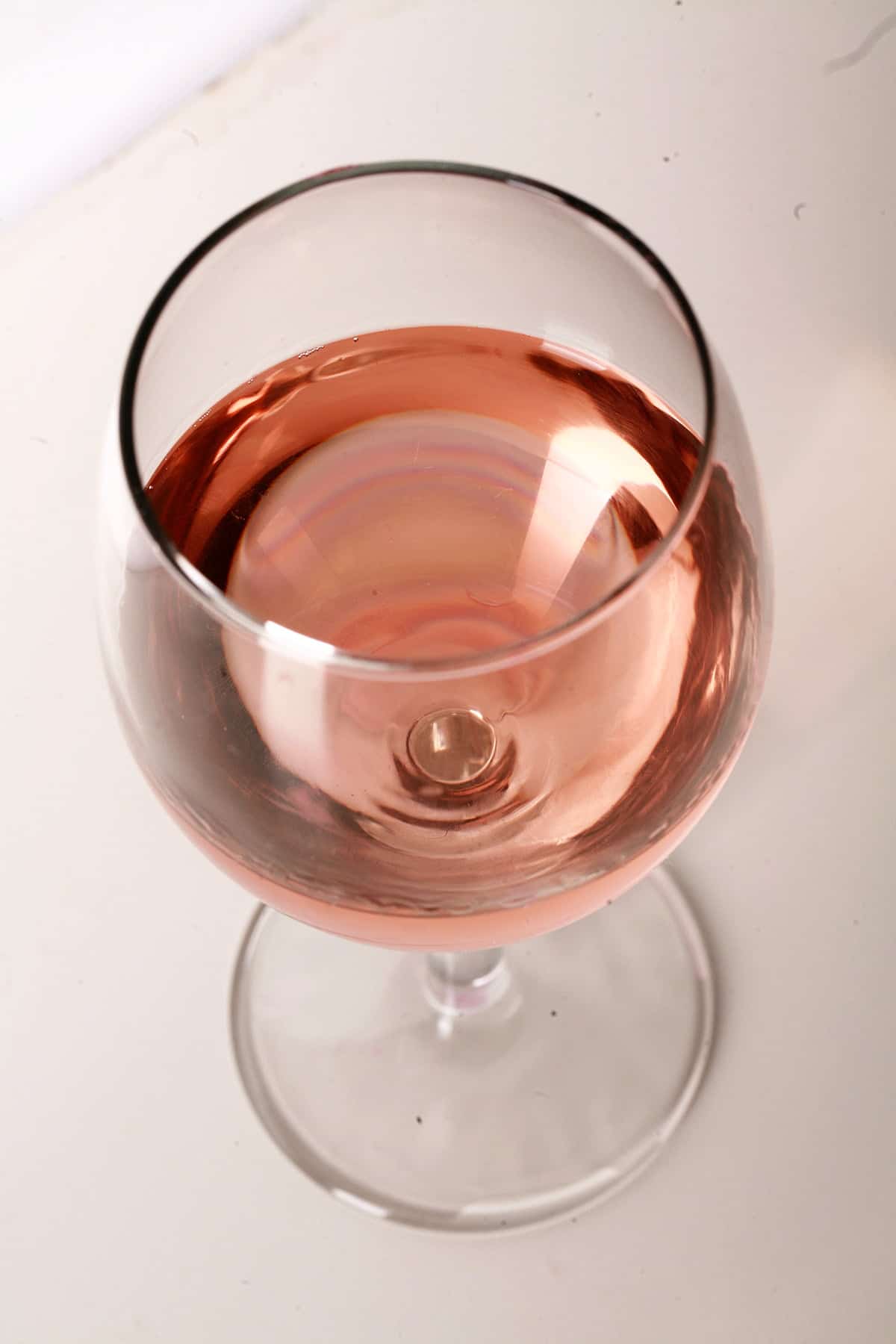 Close up view of a glass of strawberry mango wine.