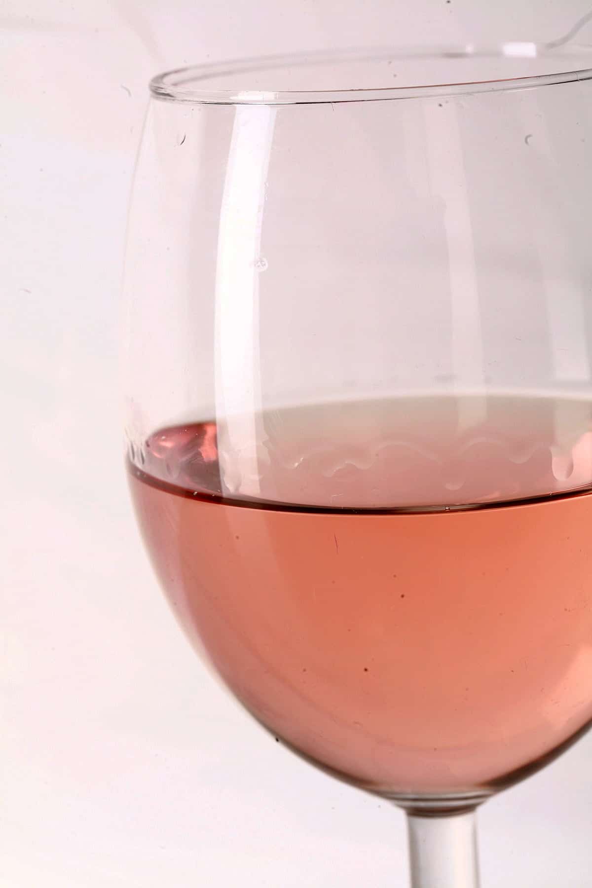 Close up view of a glass of mango strawberry wine.