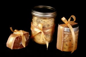 A 3 piece mustard bath gift set - the mustard bath salt, a salt scrub, and a nubby yellow mustard soap. They are all accented with yellow ribbon.