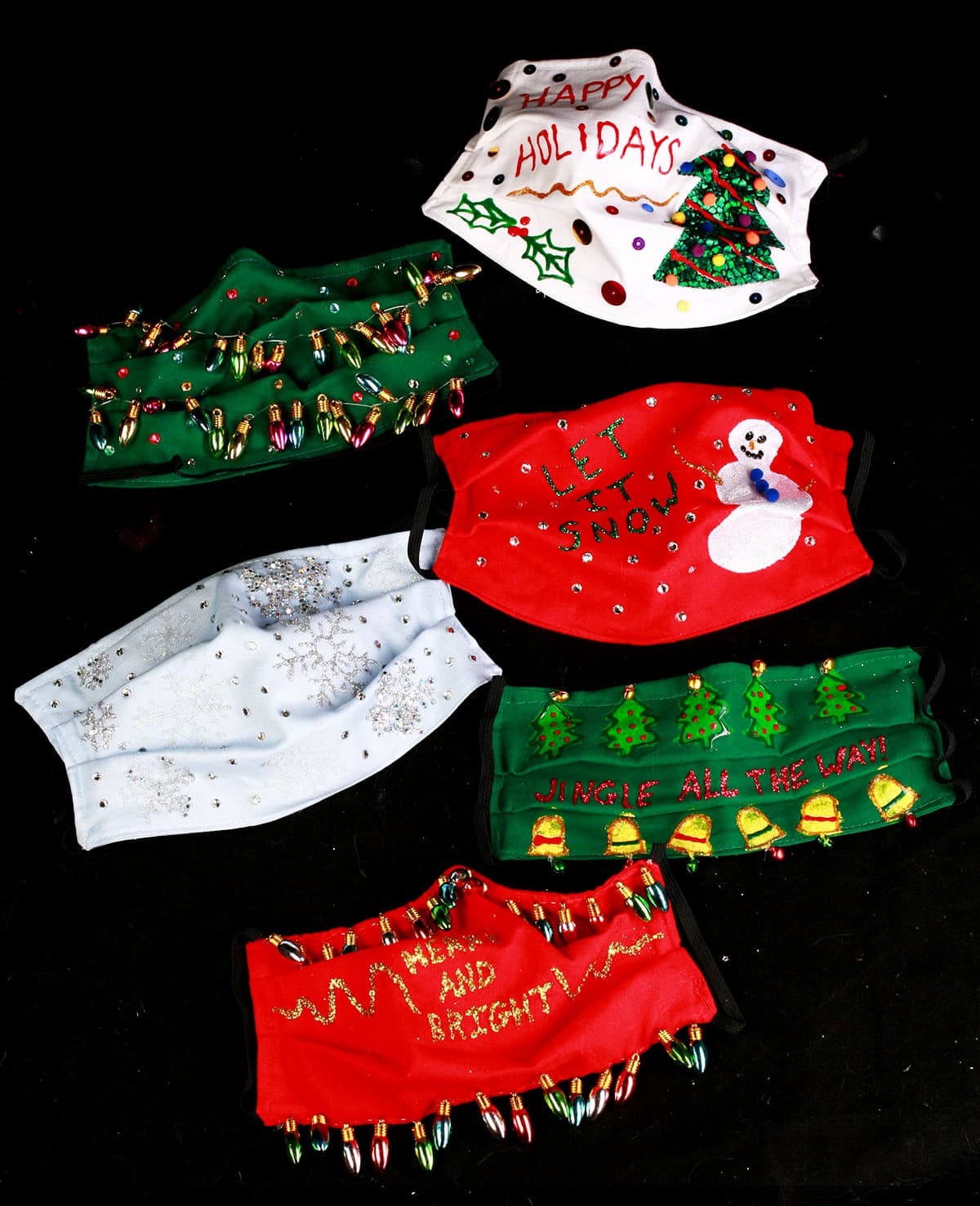 An array of 6 gaudily decorated "Ugly Christmas Sweater" style face masks, on a black background.