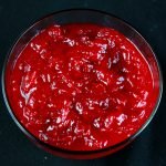 Close up view of a bowl of chunky cranberry sauce.