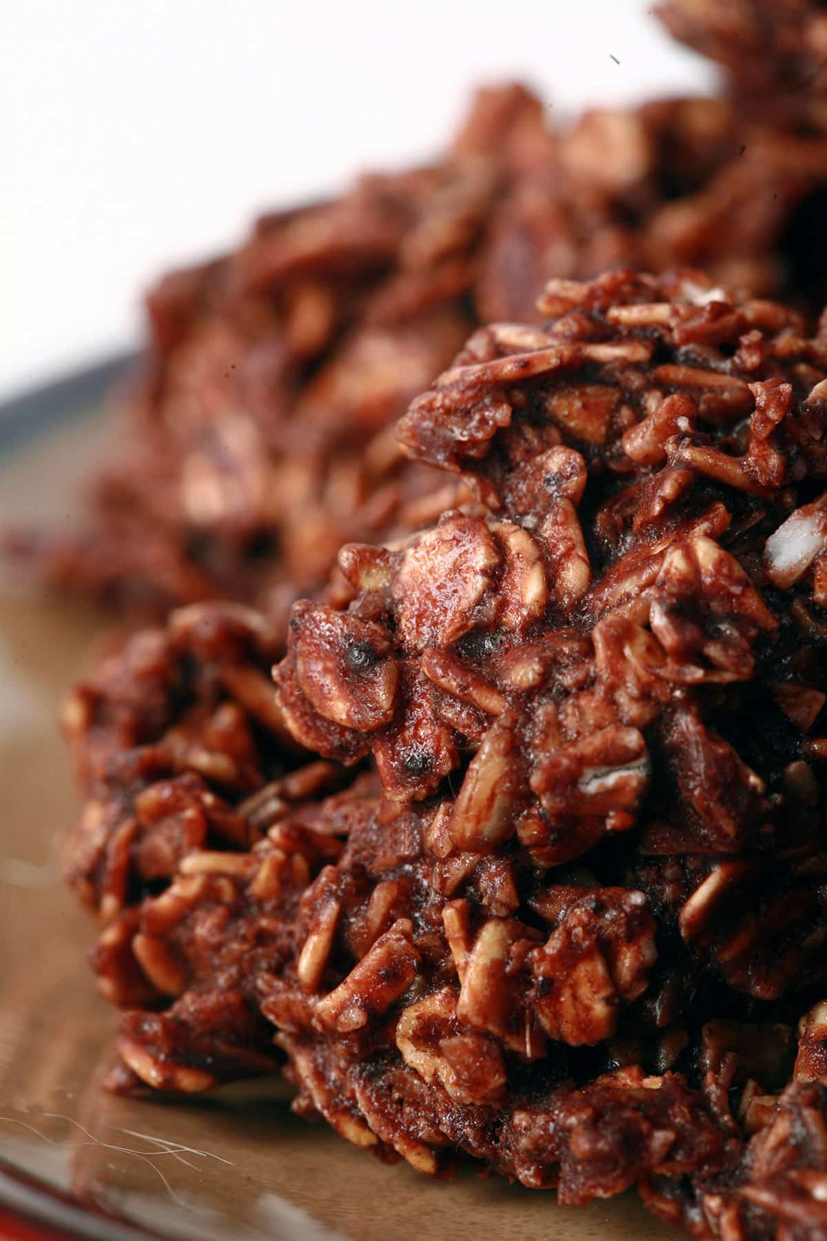 A plate stacked with no bake chocolate haystack cookies.