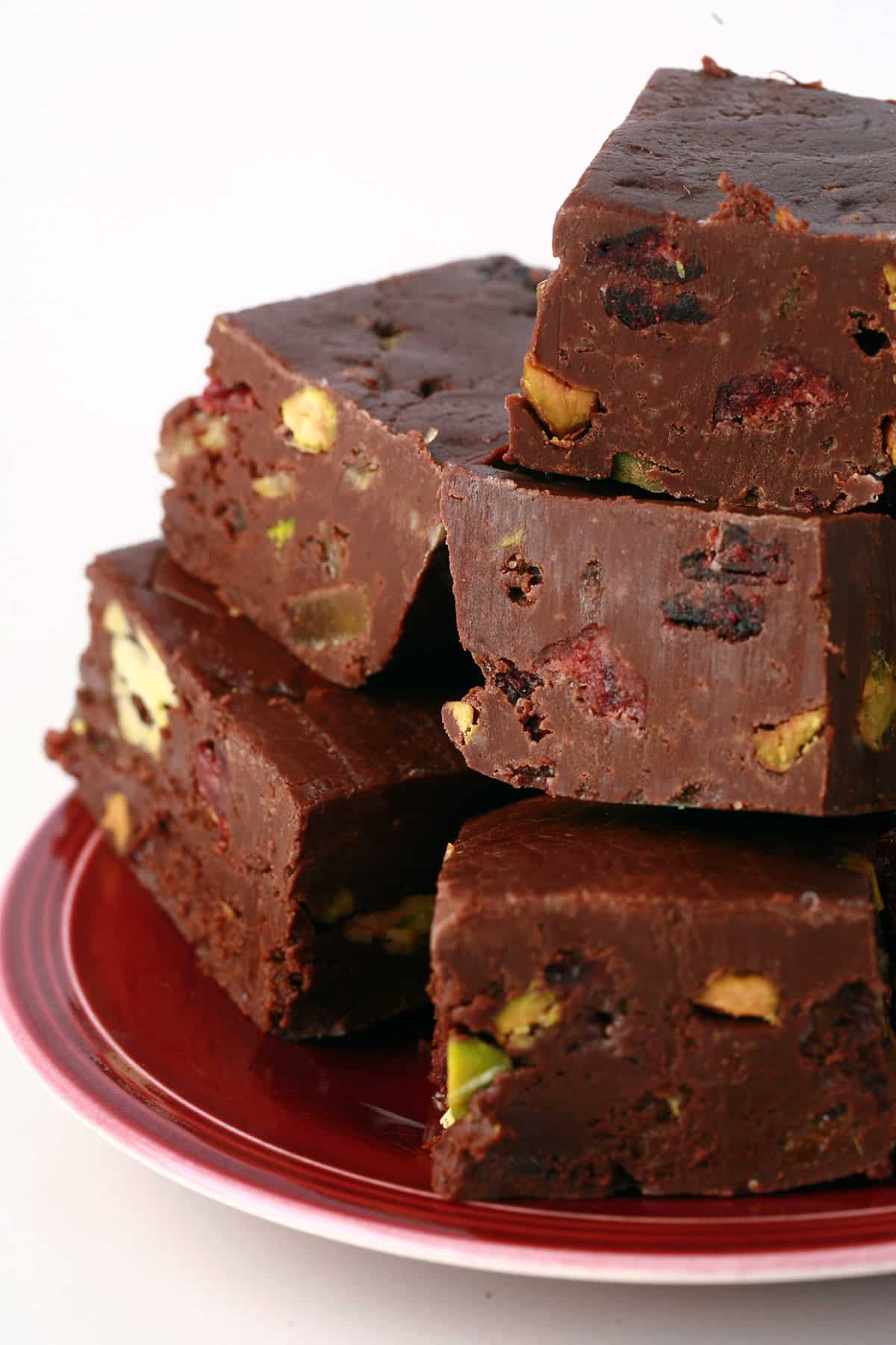 A small stack of festive holiday fudge on a plate.