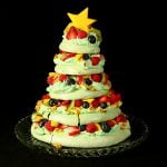 A 5 tier Christmas Tree Pavlova, topped with a star shaped slice of mango