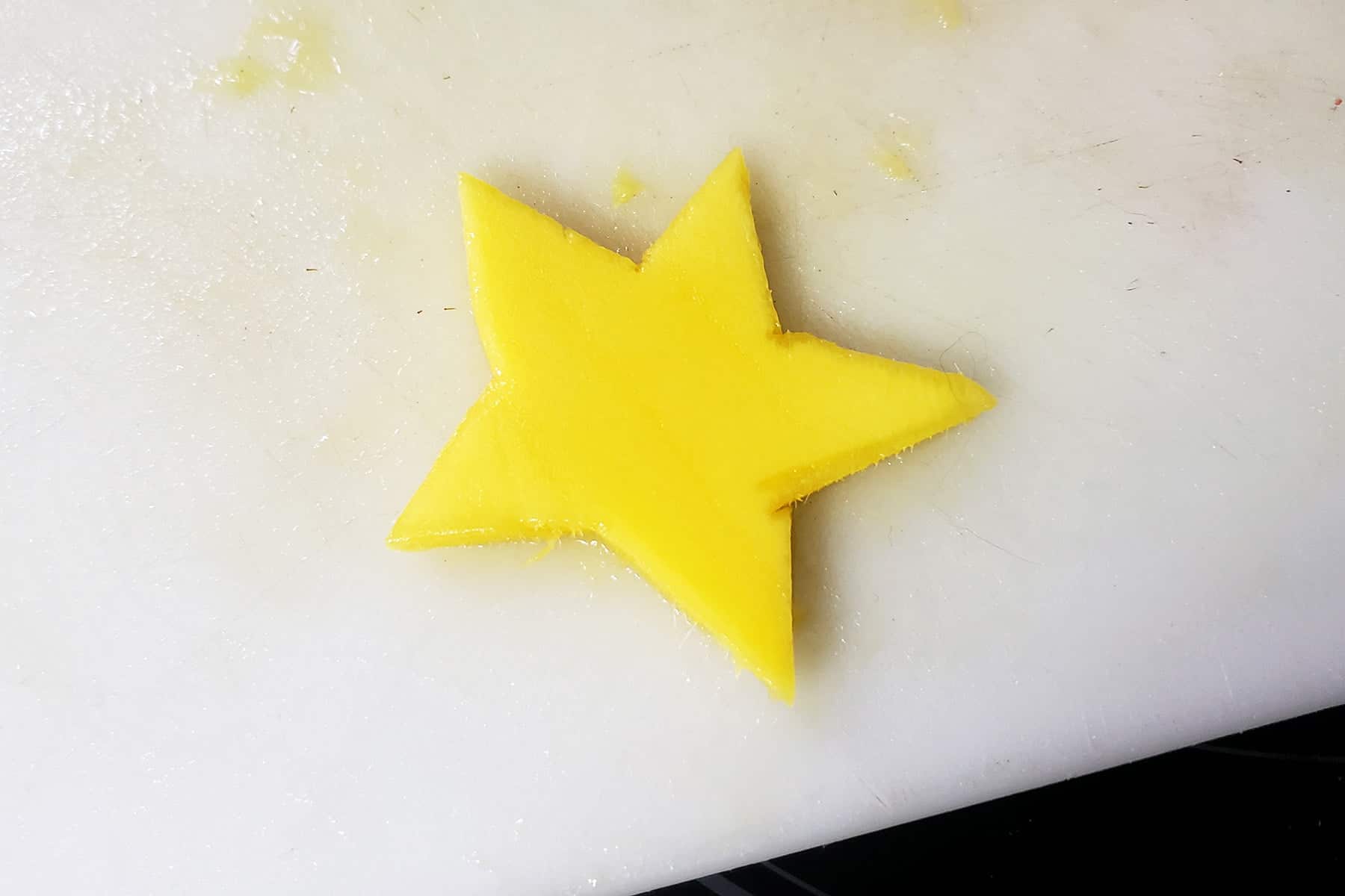 A slice of mango has been cut to look like a star.