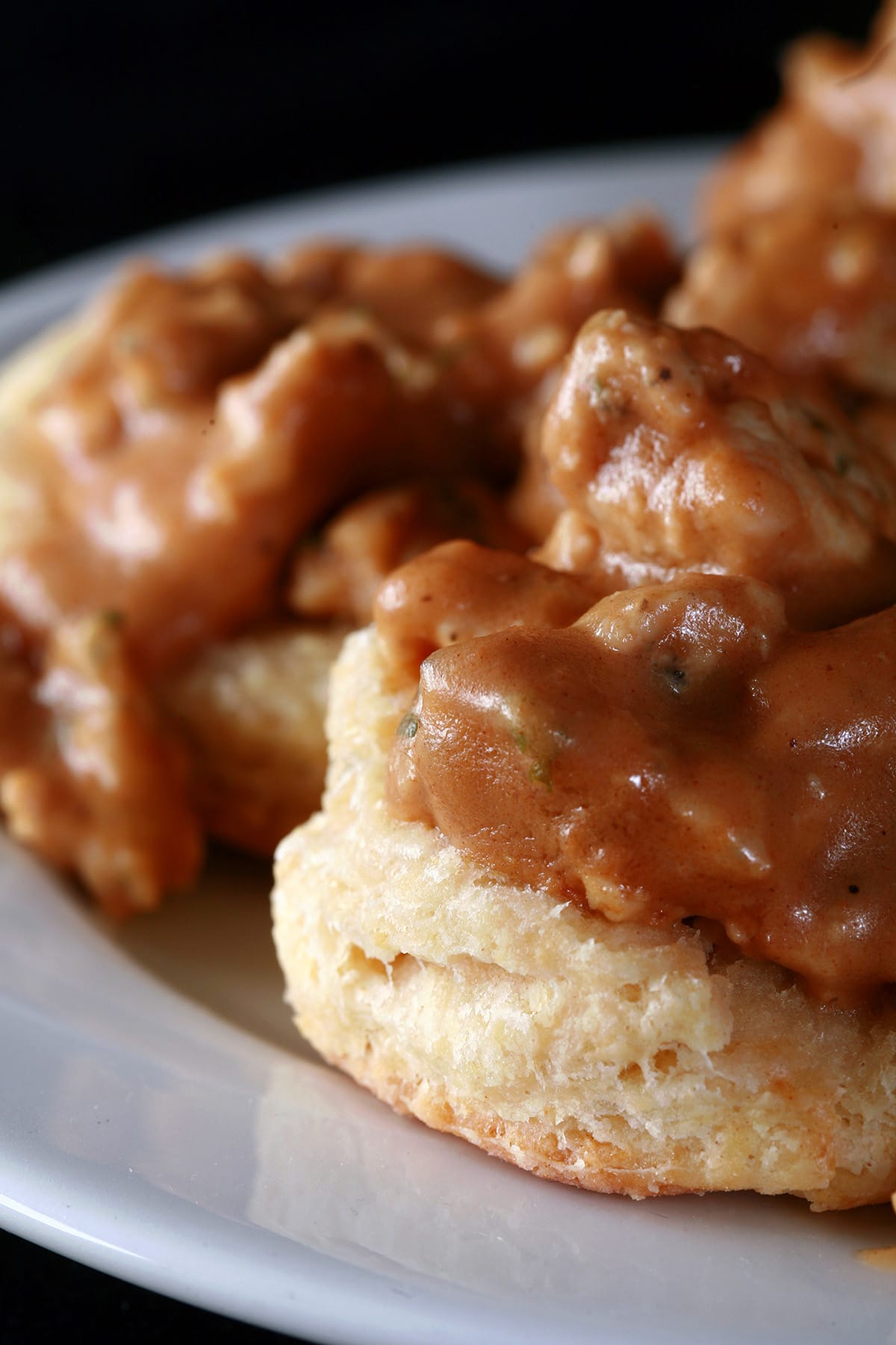 A serving of biscuits and gravy, on a small plate.