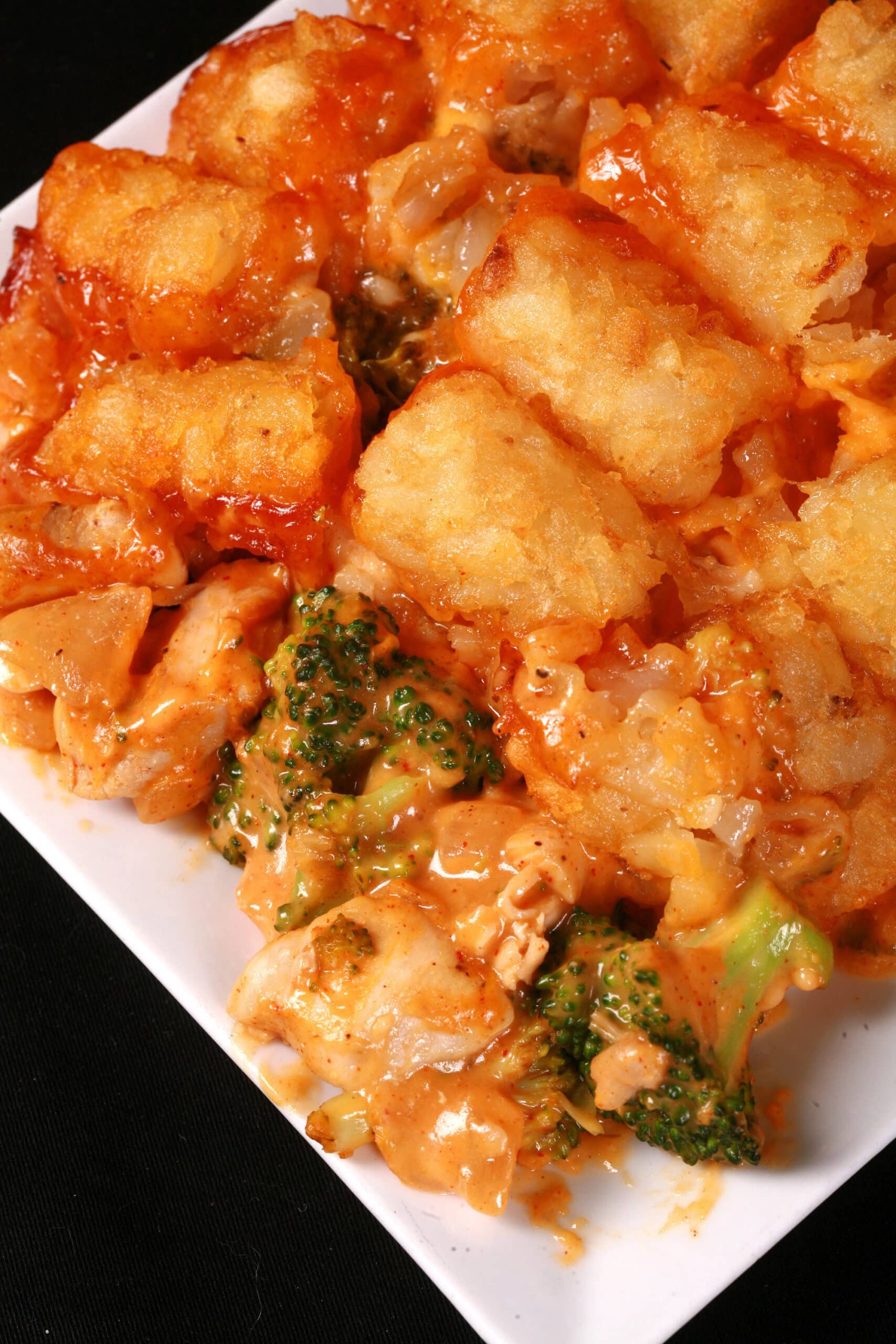 A pan of cheesy chicken and broccoli tater tot casserole.