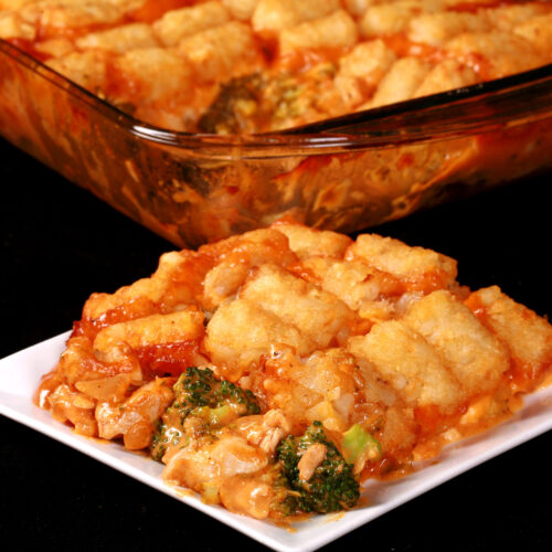 A pan and plate of chicken and broccoli casserole with tater tots on top.