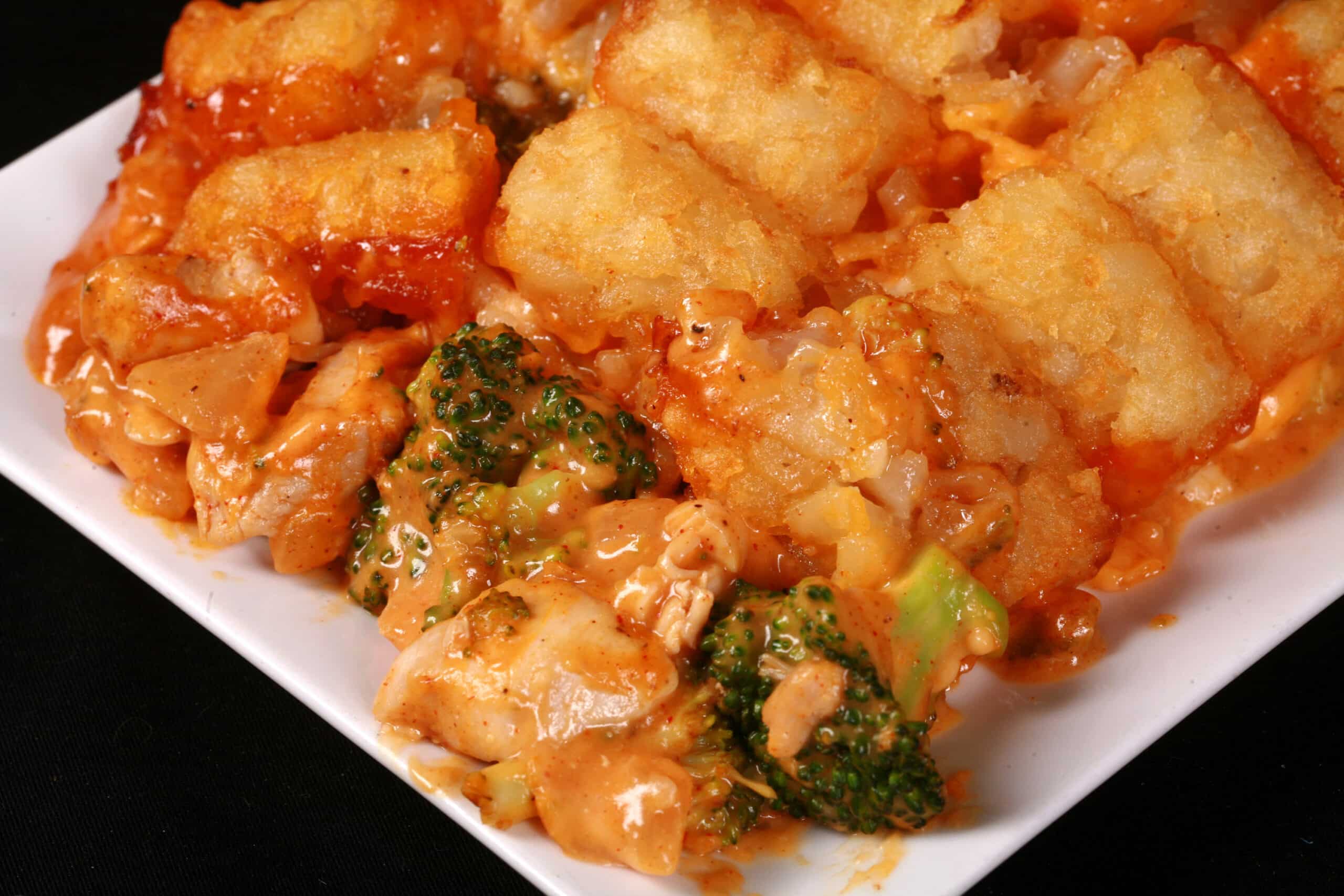 A plate of cheesy chicken and broccoli tater tot casserole.