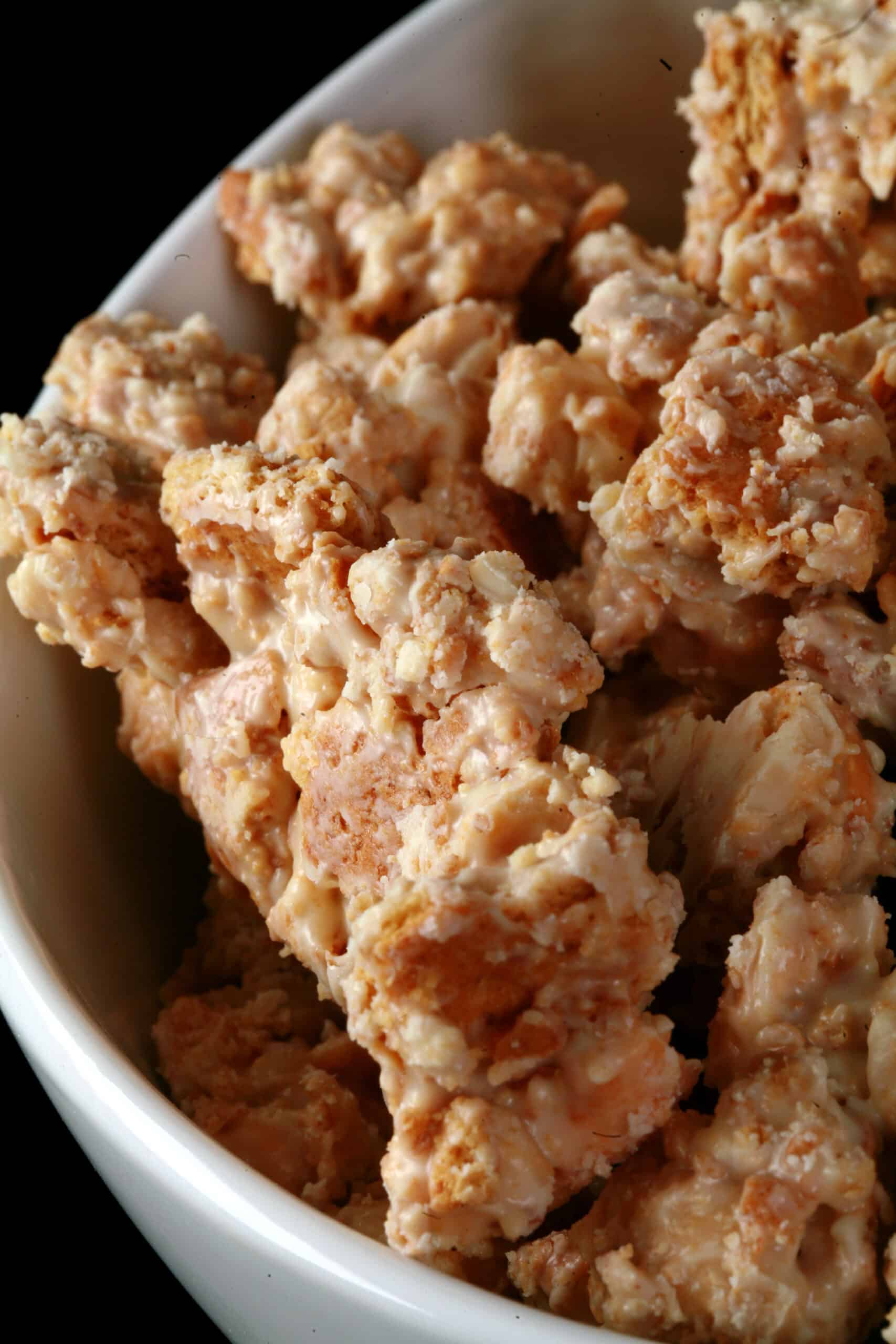 A bowl of homemade clodhoppers: clusters of cashew pieces, graham crackers, and white chocolate.