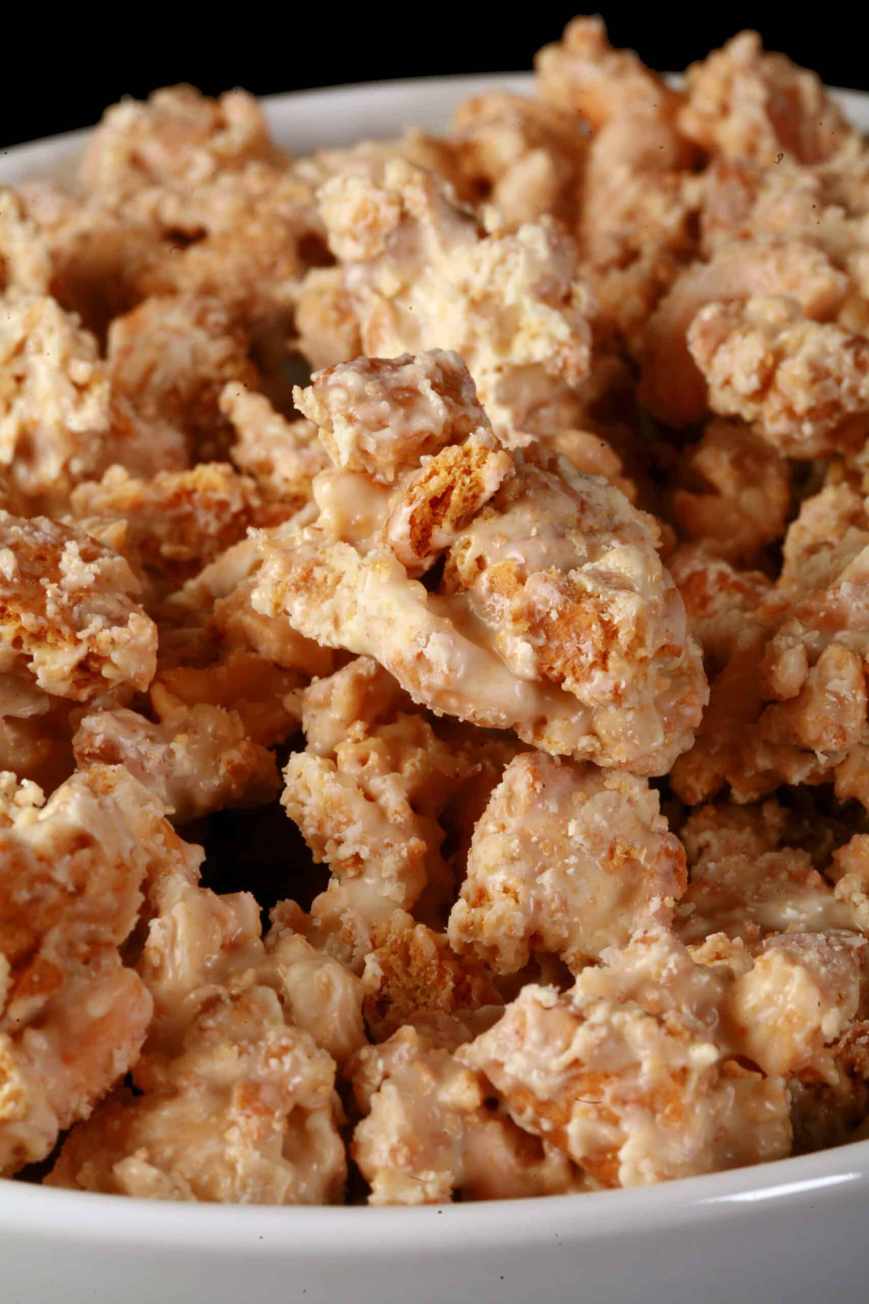 A bowl of homemade clodhoppers: clusters of cashew pieces, graham crackers, and white chocolate.