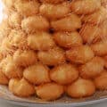 A tall croquembouche with a web of sugar spun around it.