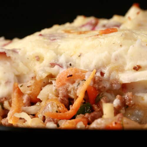 A close up photo of a serving of cottage pie.