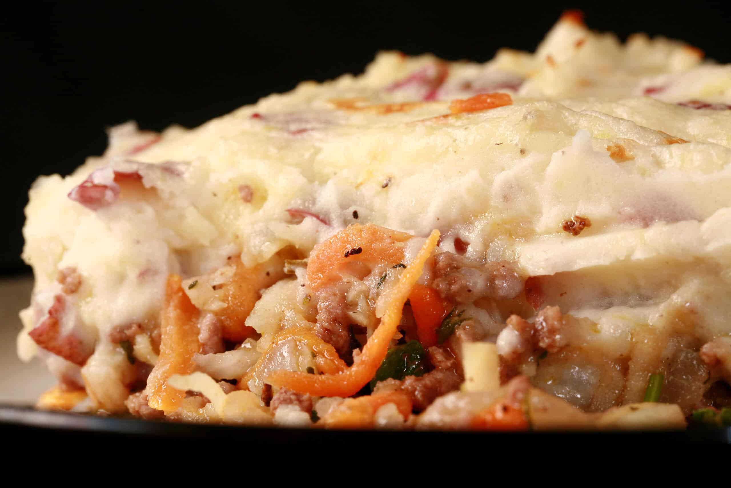 A close up photo of a serving of cottage pie.