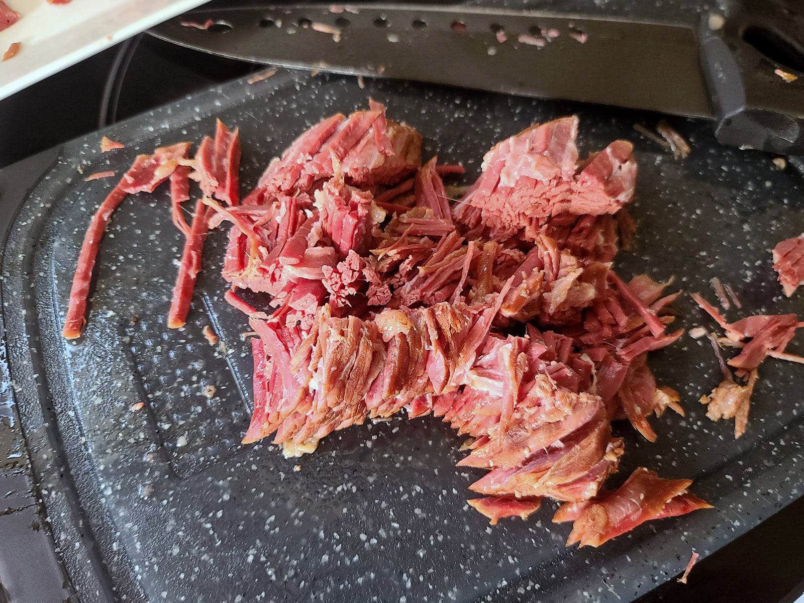 Chopped corned beef on a cutting board.