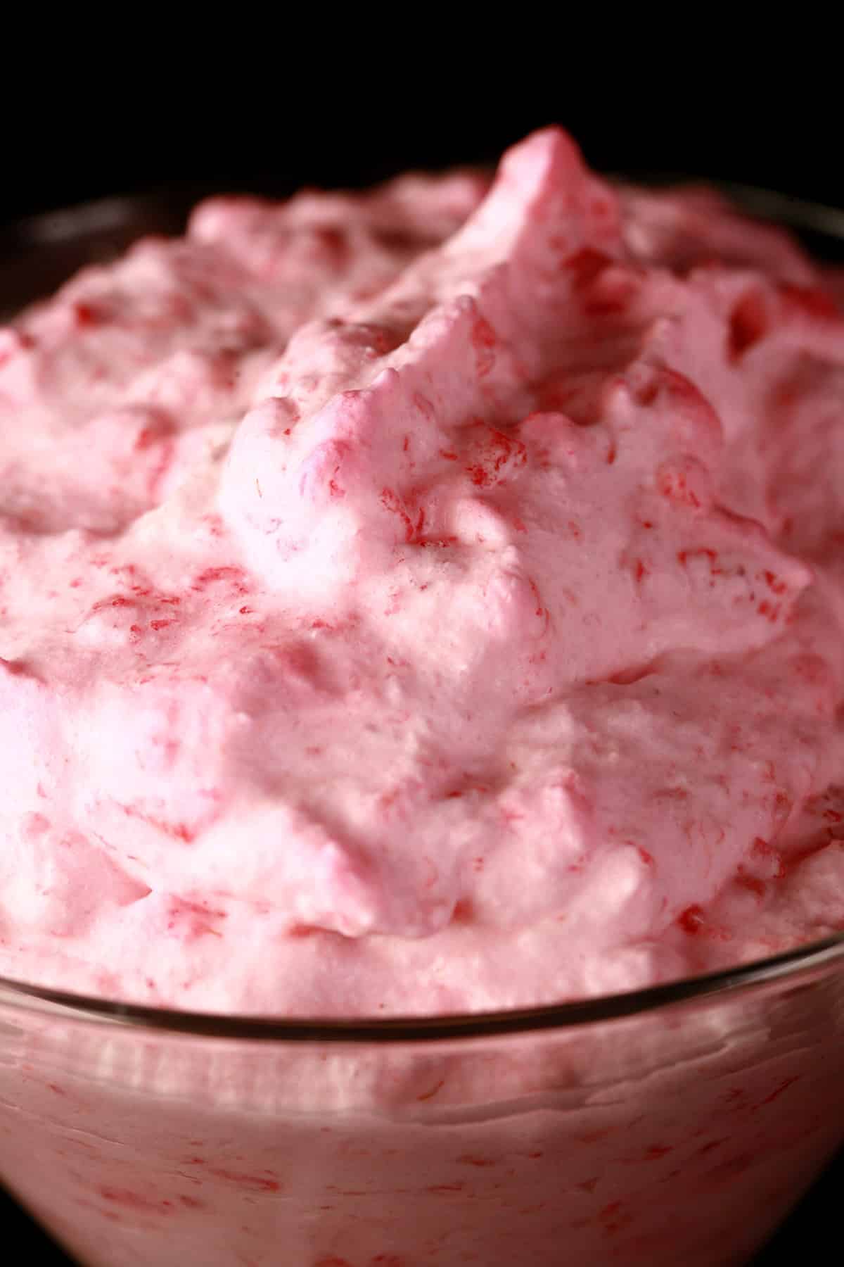 A close up view of a serving of traditional raspberry mousse with egg whites.