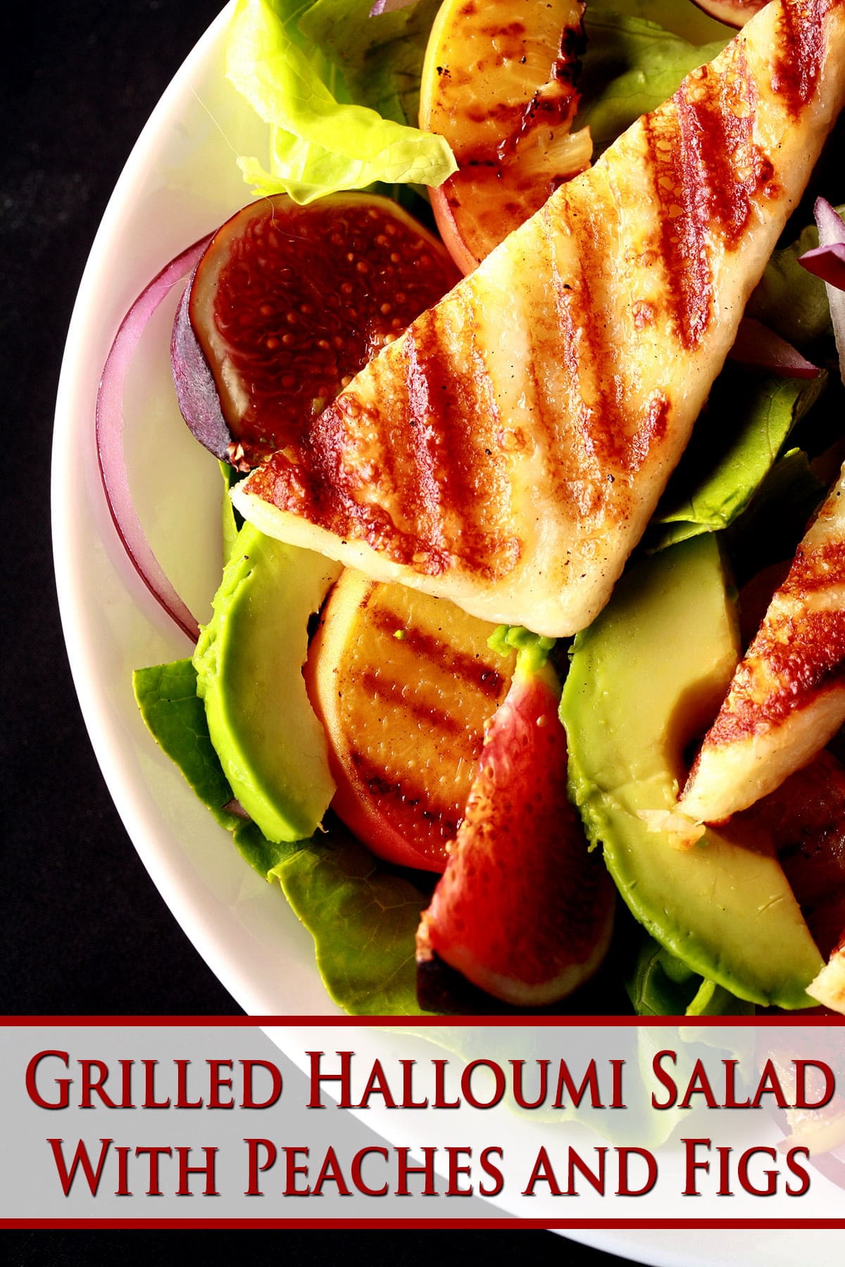 A bowl of salad, with sliced figs, grilled peaches, and strips of grilled white cheese. Grilled Halloumi Salad with Peaches and Figs