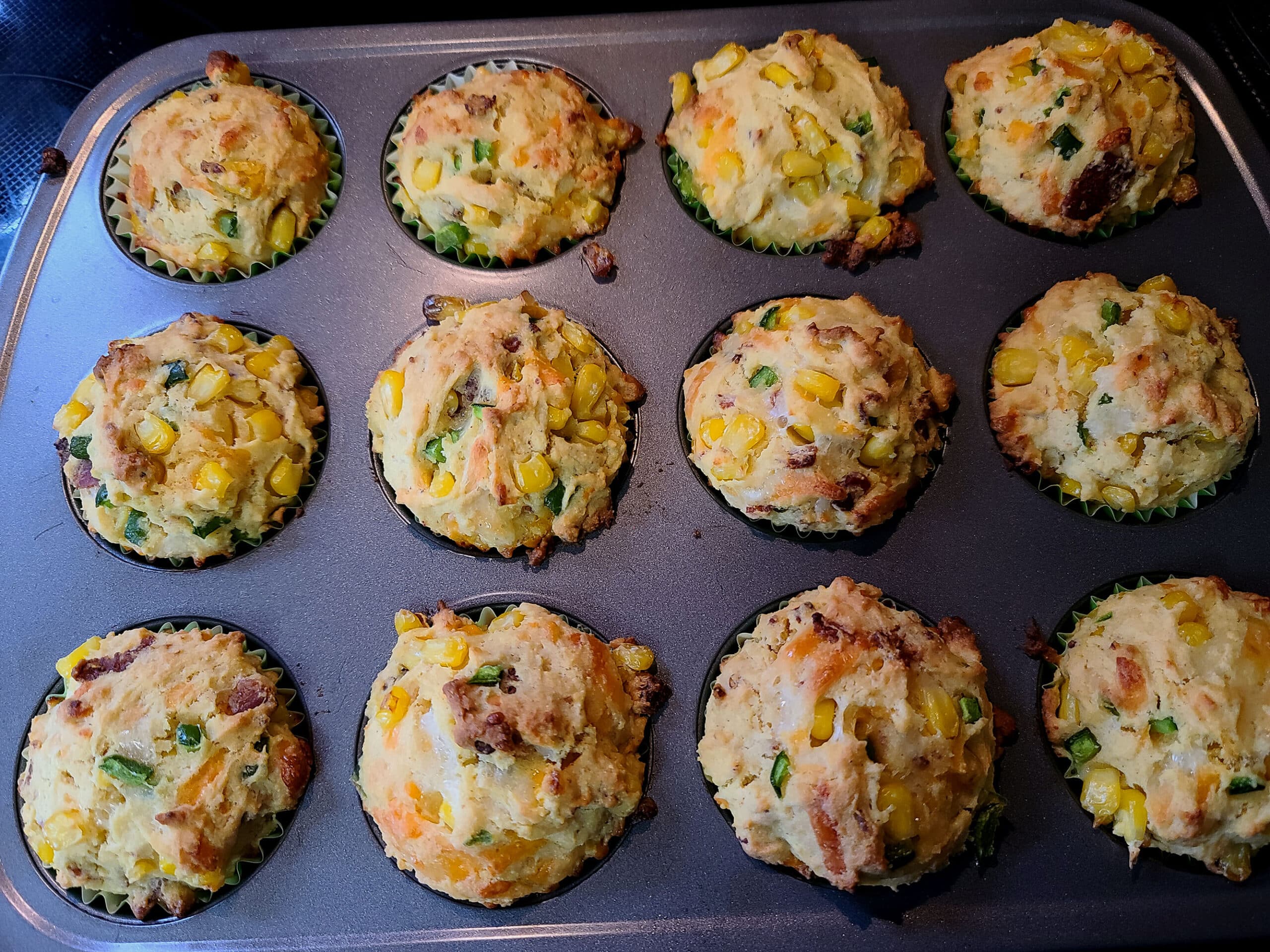 A pan of freshly baked loaded breakfast corn muffins.