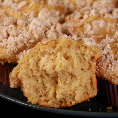 A plate of fresh pear muffins with cardamom streusel topping.