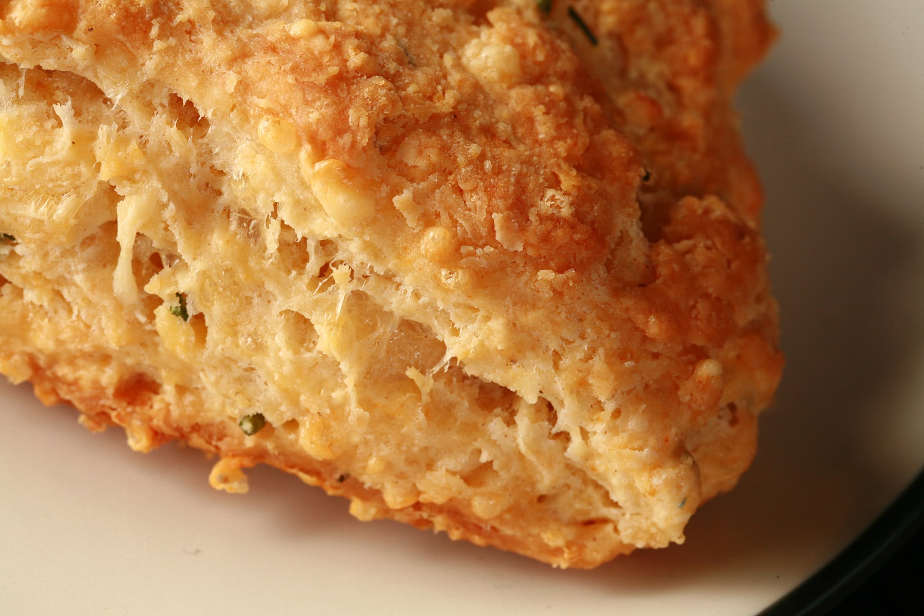A close up view of Smoked Gouda scones on a small white plate.