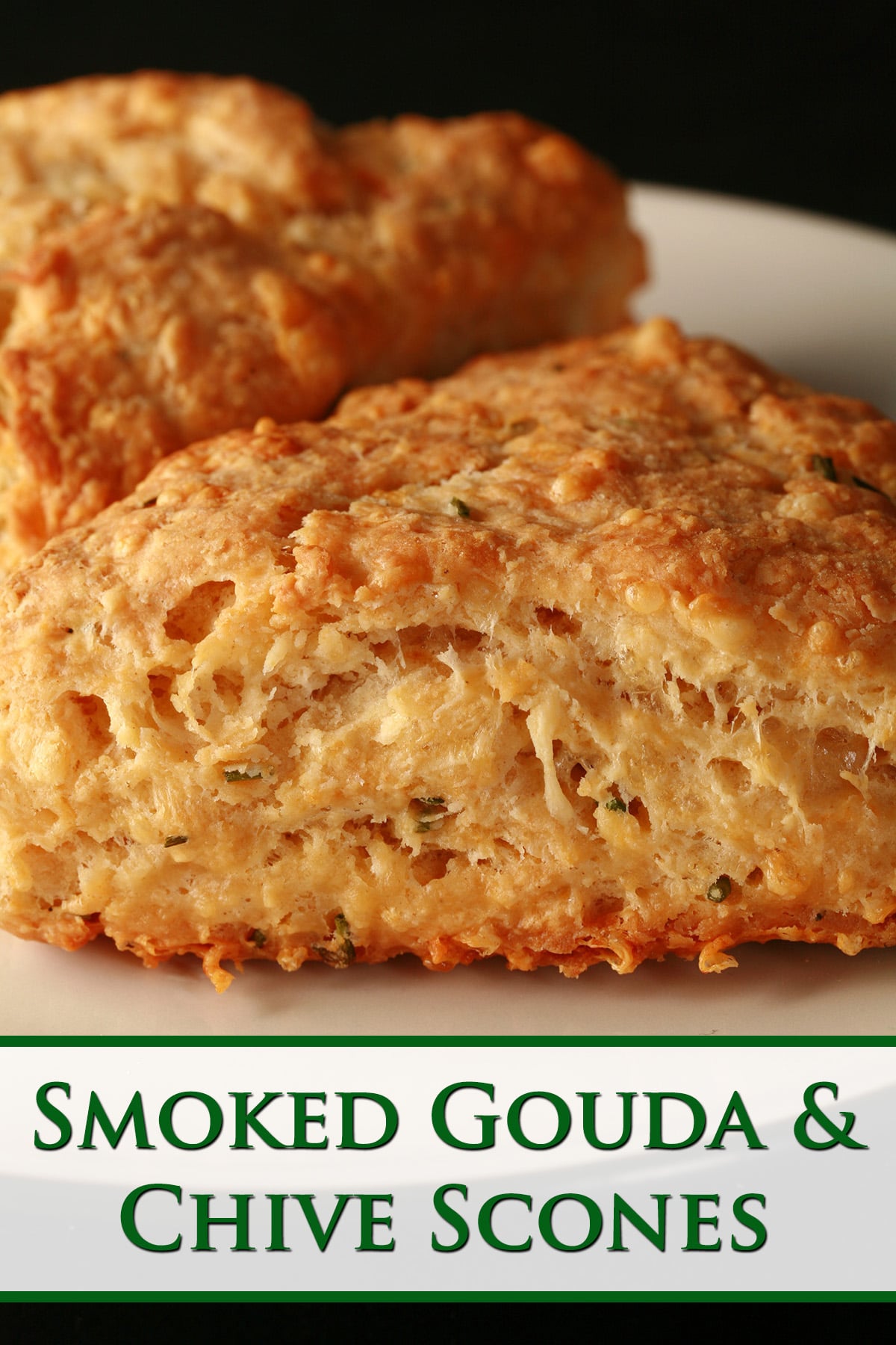 A close up view of Smoked Gouda and Chive scones on a small white plate.