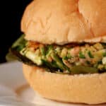 A spinach feta salmon burger, with lemon aioli and lettuce.