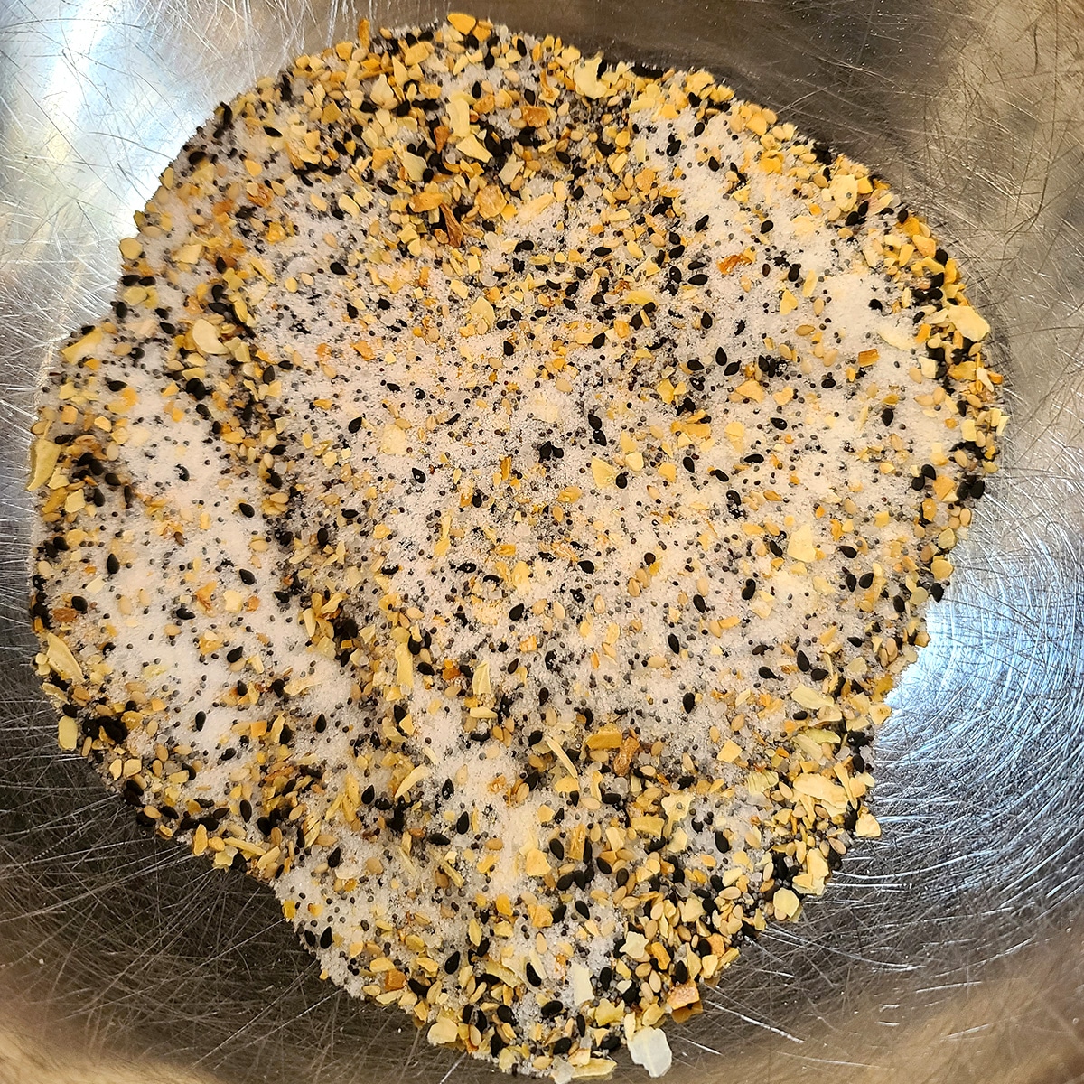 Sugar and everything bagel seasoning, in a metal bowl.