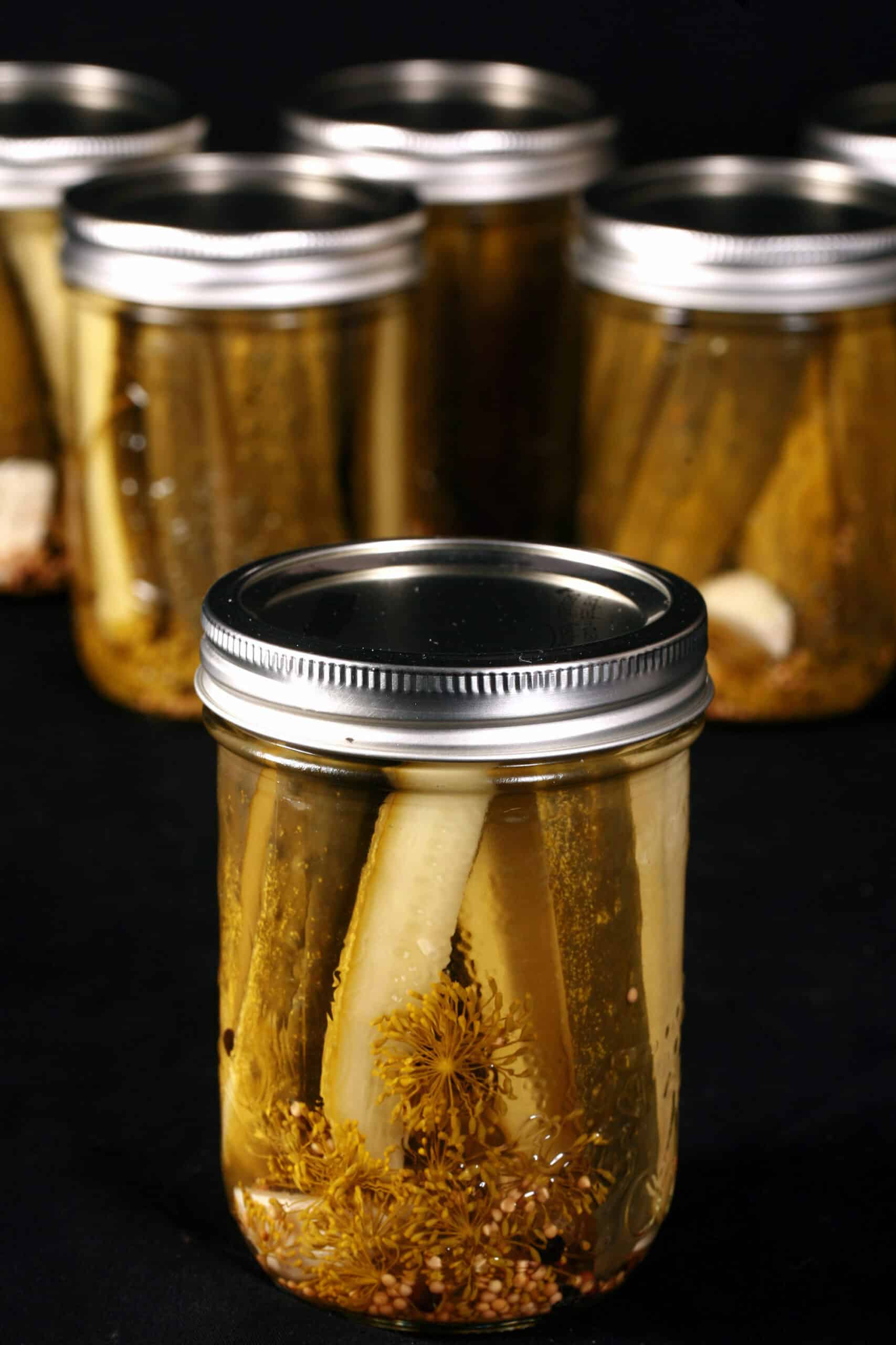 Several jars of homemade garlic dill pickles.
