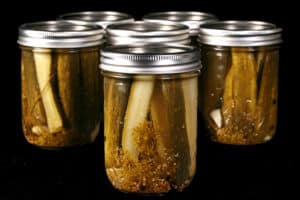 Several jars of homemade garlic dill pickles.