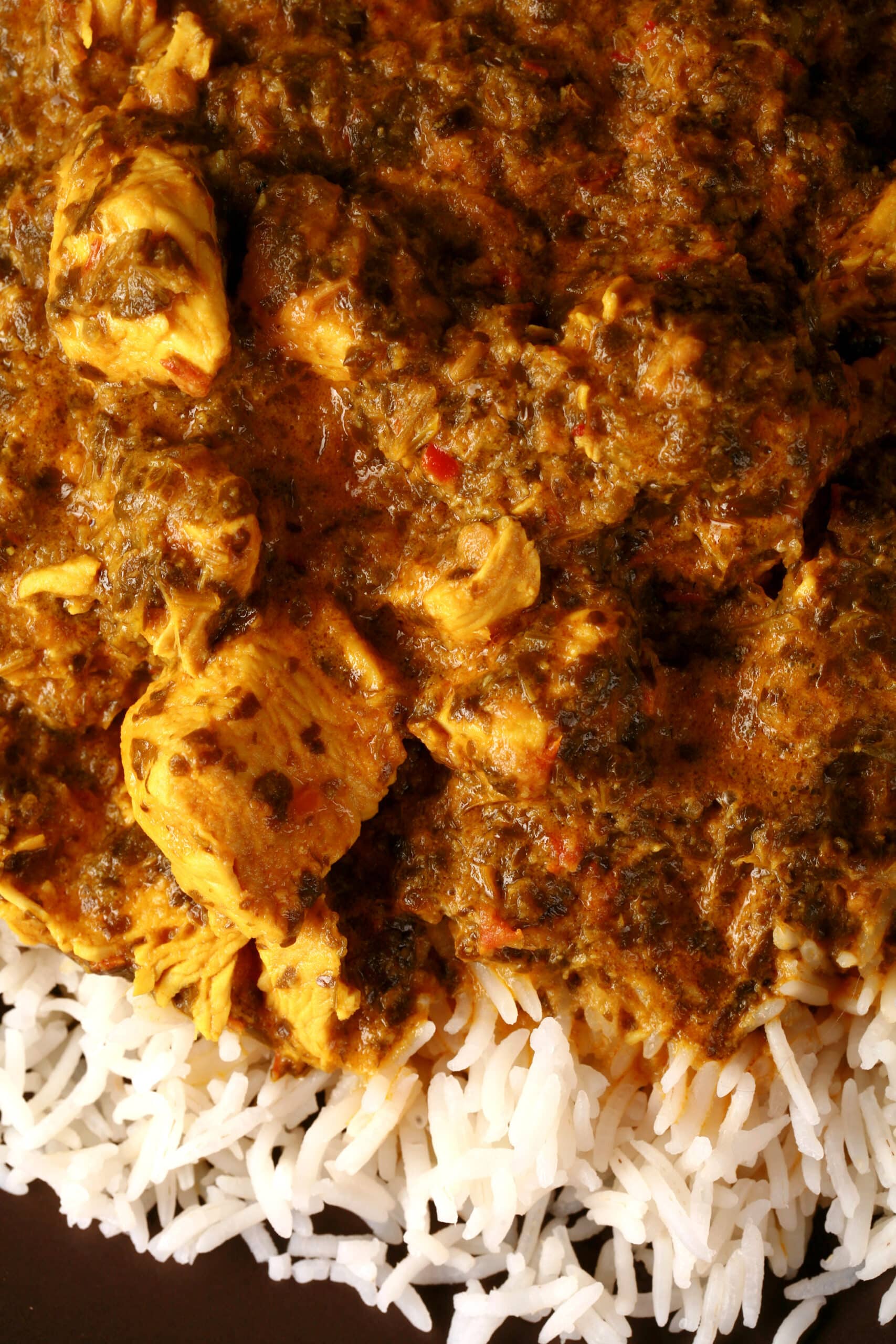 A plate of coriander chicken, served over basmati rice.