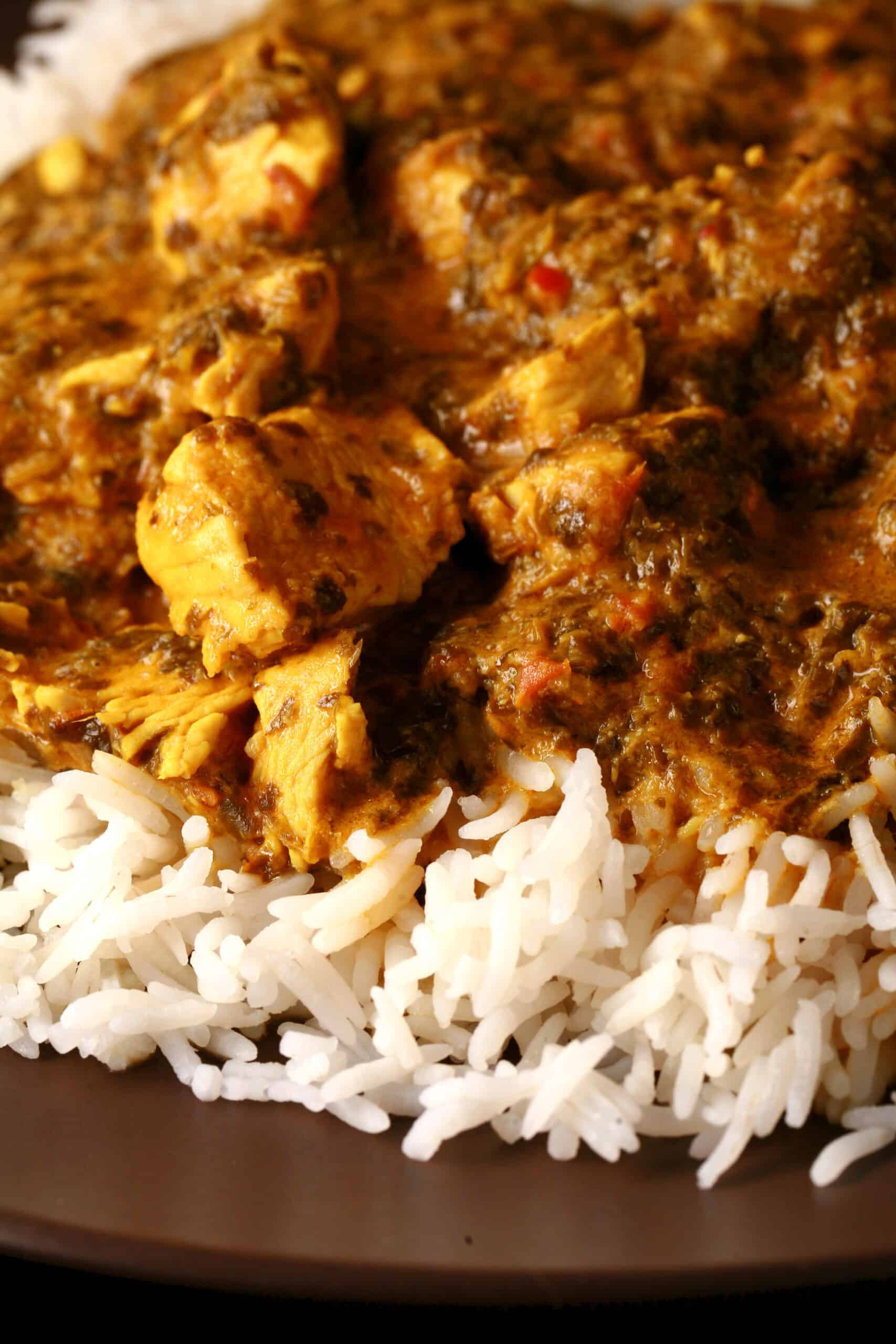 A plate of coriander chicken, served over basmati rice.