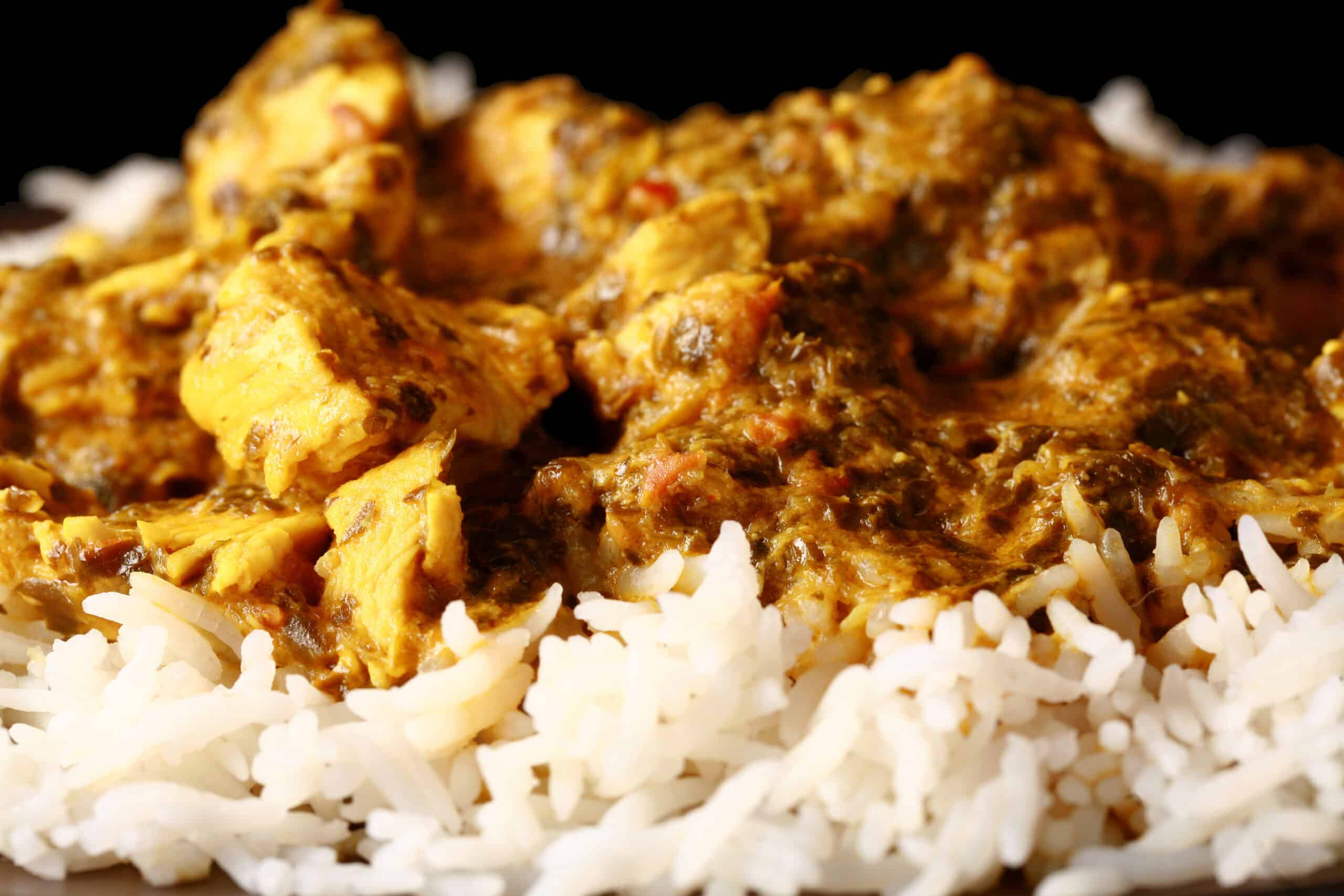 A plate of coriander chicken, served over basmati rice.