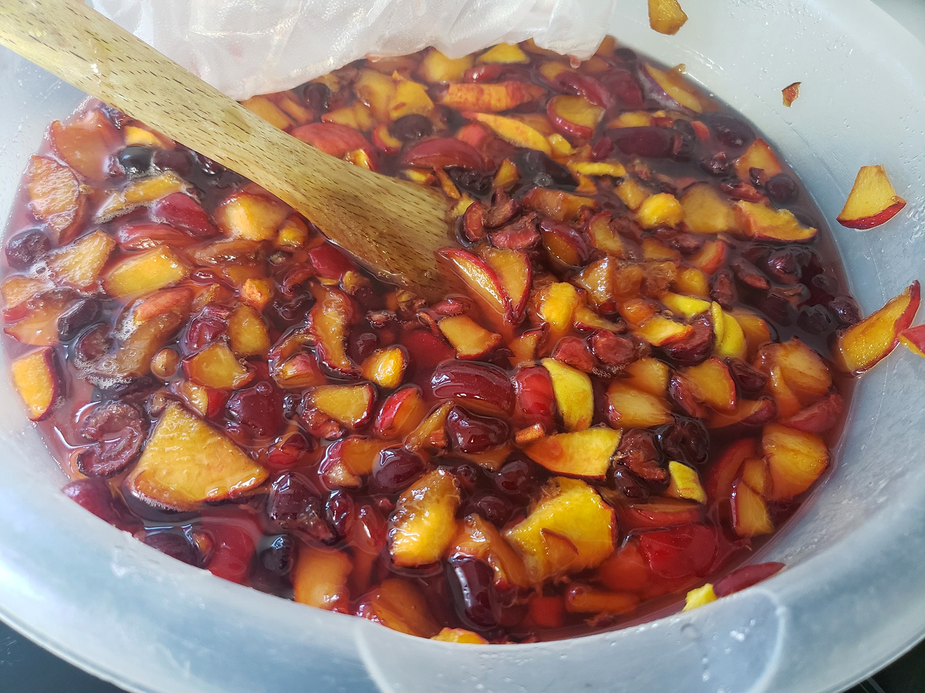 A big bowl of chopped stone fruit, macerating in a sugar syrup.