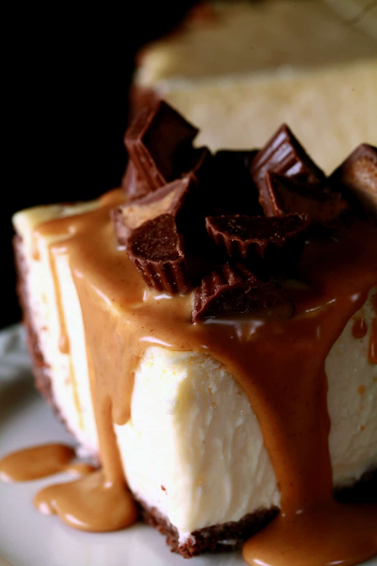 A close up view of a slice of peanut butter cup cheesecake.