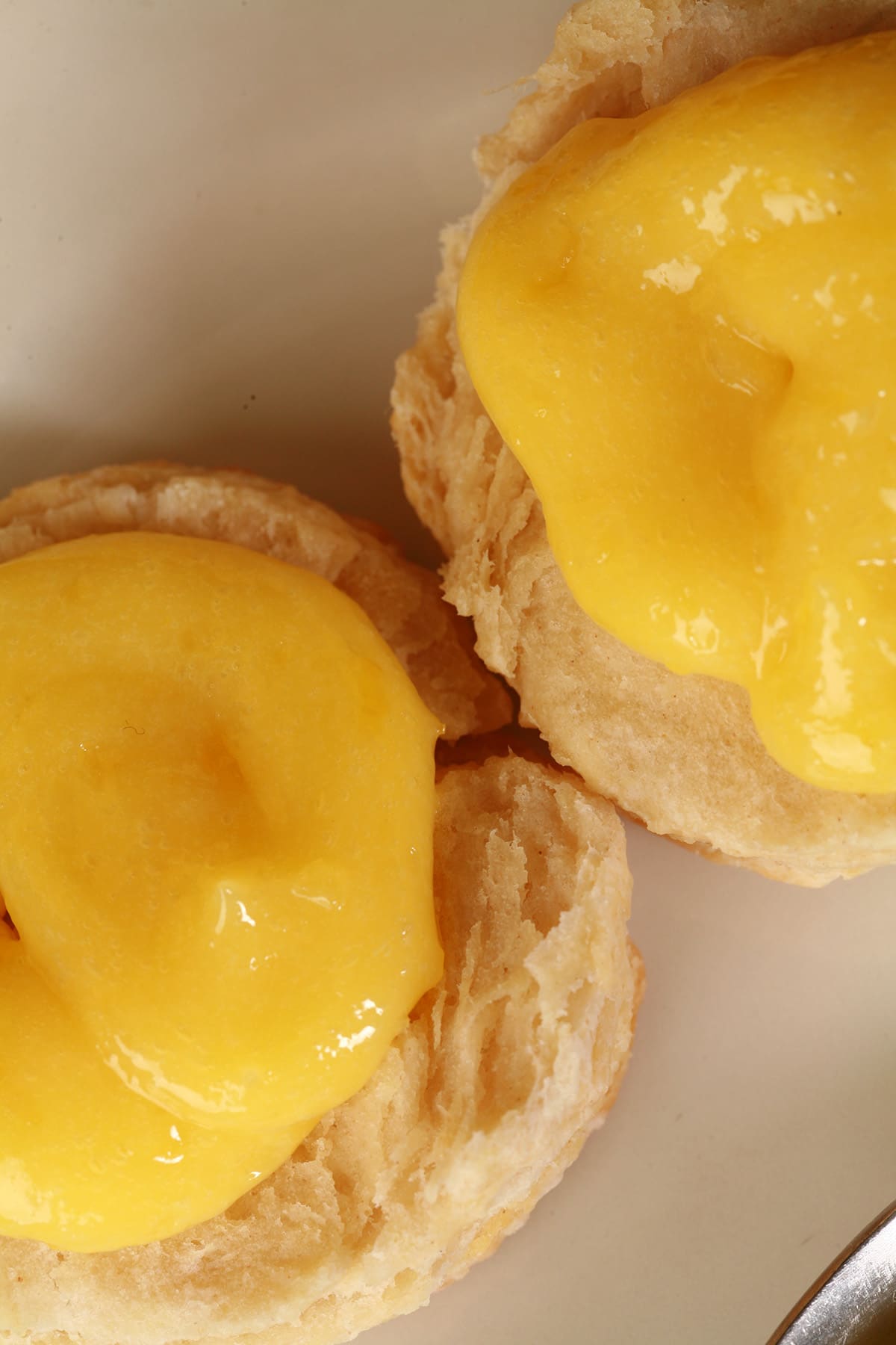 Two biscuits topped with lemon curd.