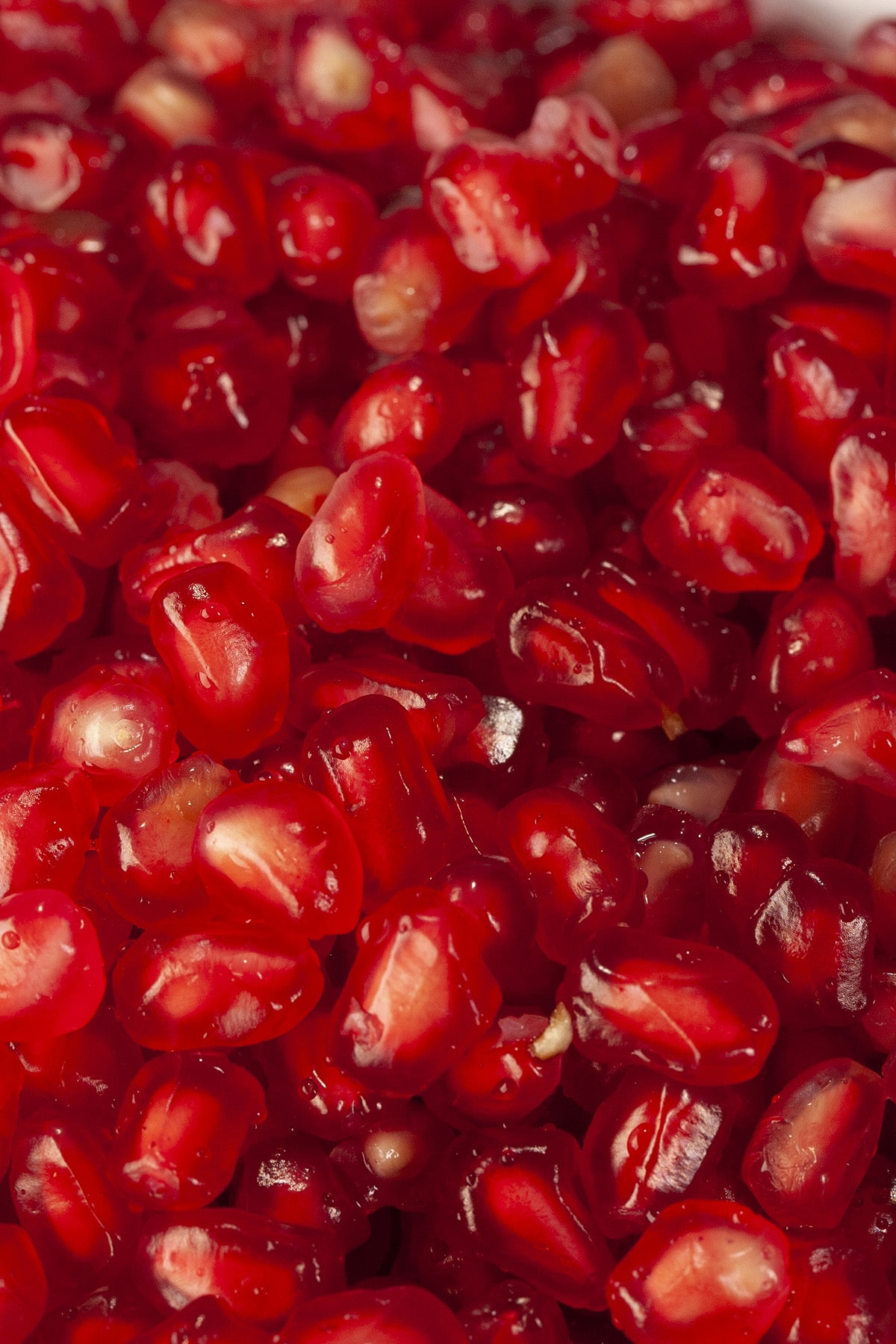 A close up view of a bowl of pomegranate arils.
