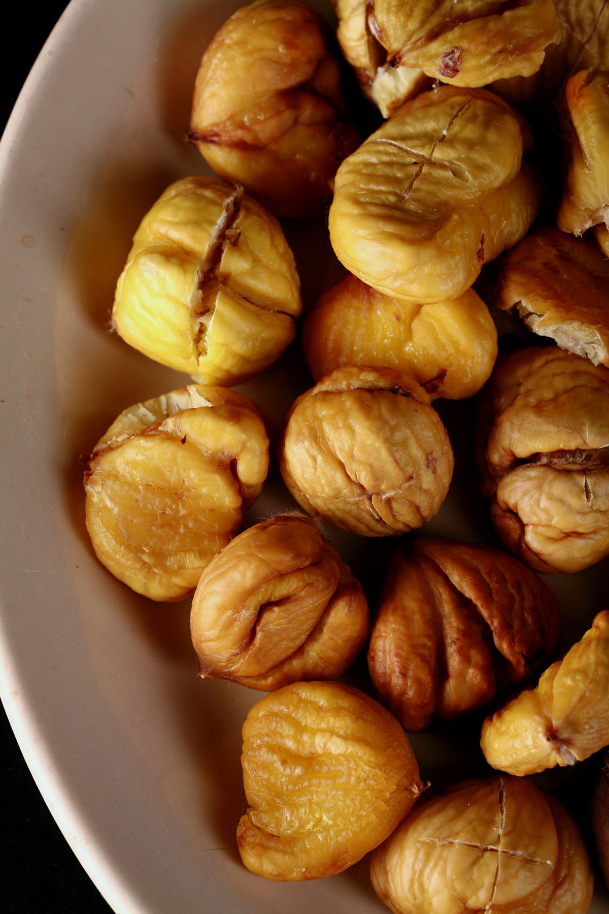 A bowl of peeled oven roasted chestnuts.