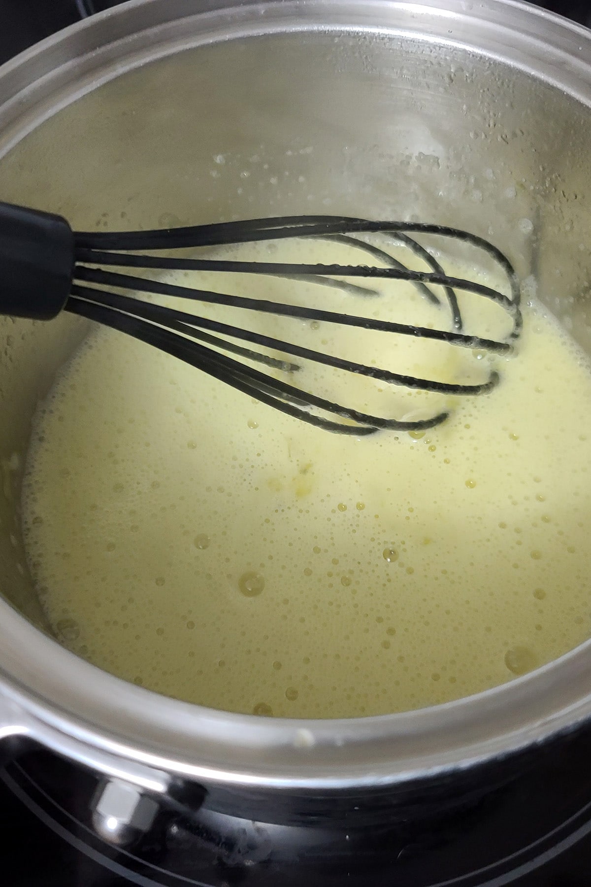 Kiwi curd cooking in a pot.