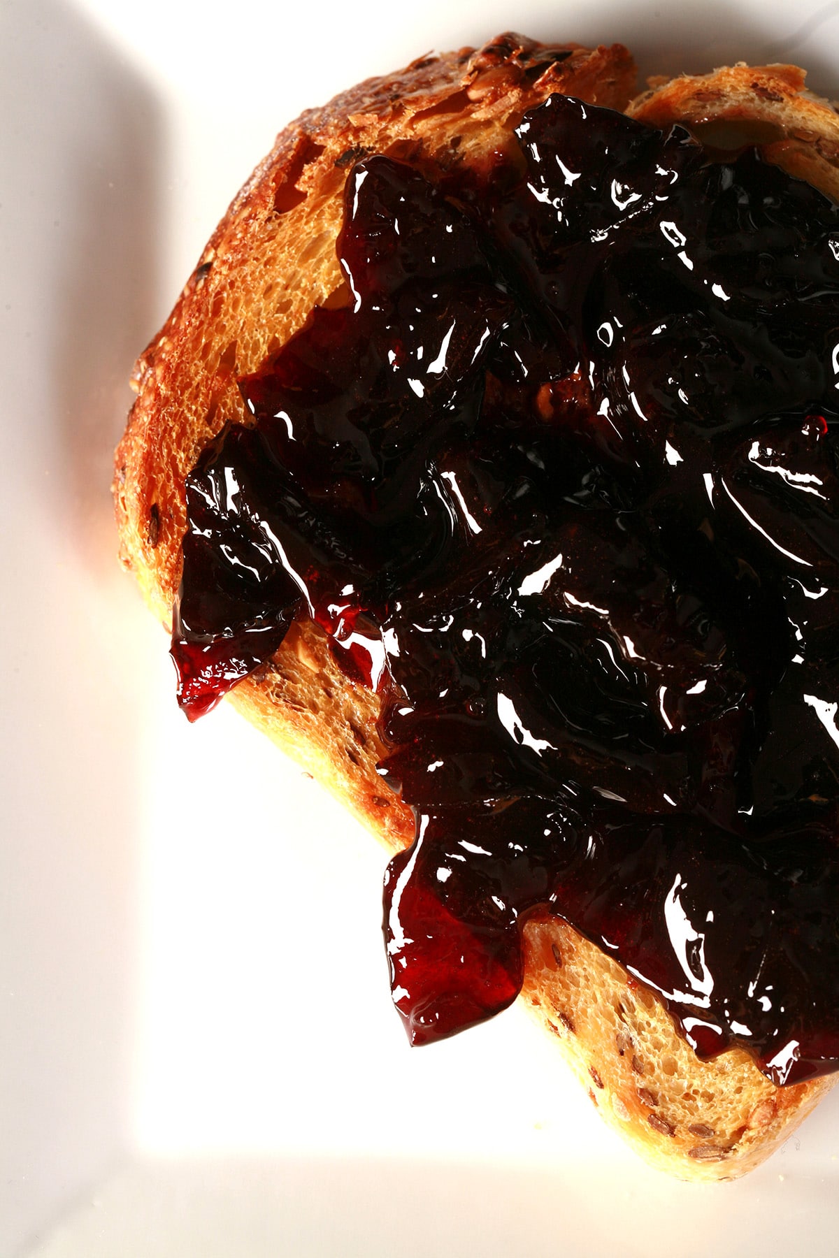 A slice of toast spread with small batch cherry jam.