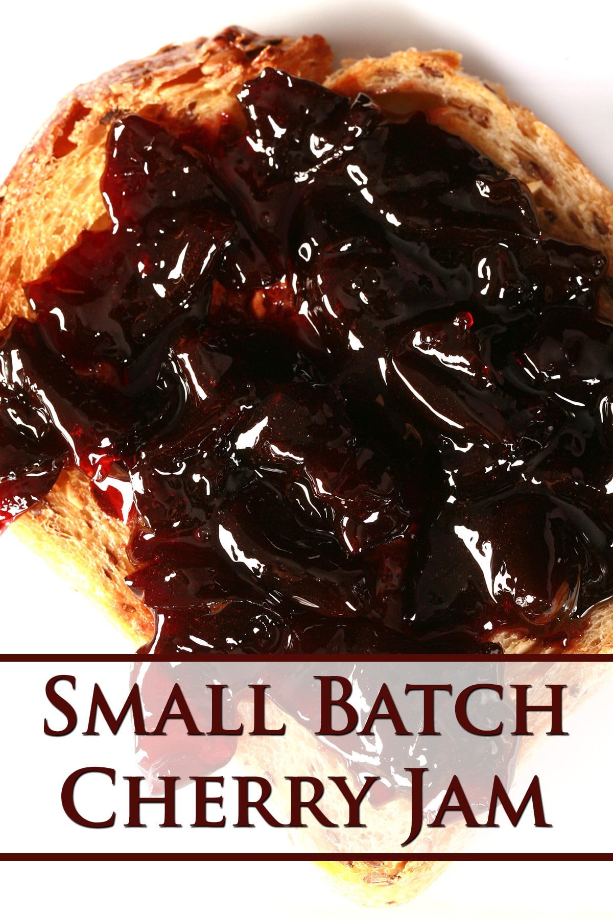 A slice of toast spread with small batch cherry jam.