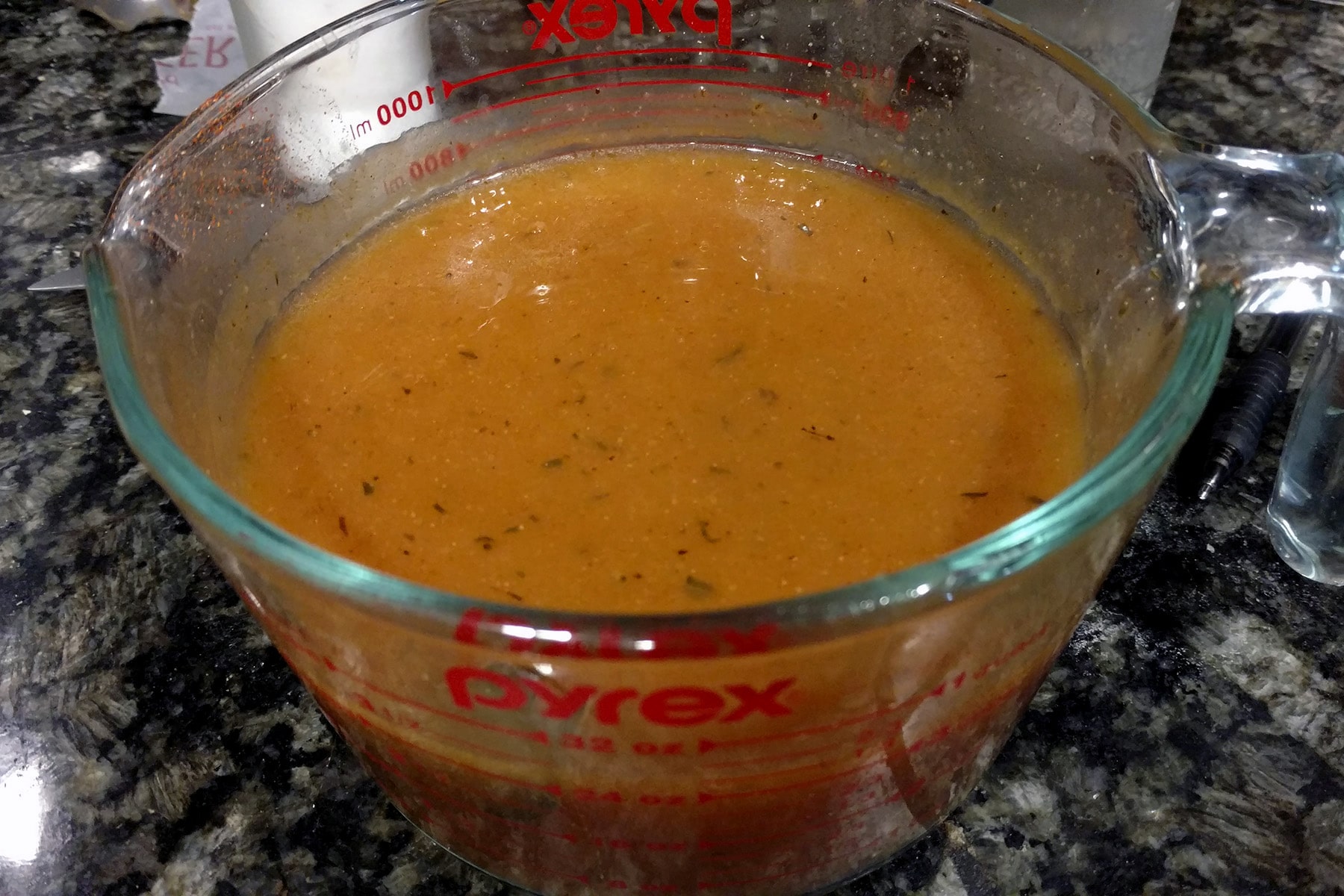 A 4 cup glass measuring cup filled with homemade Chalet Sauce.