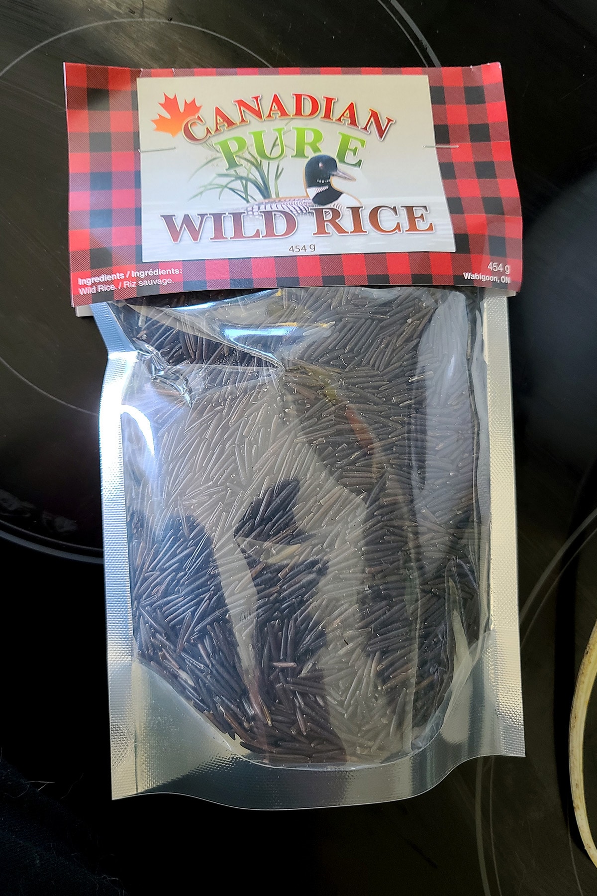 A bag of Canadian Wild rice, sitting on a stove top.