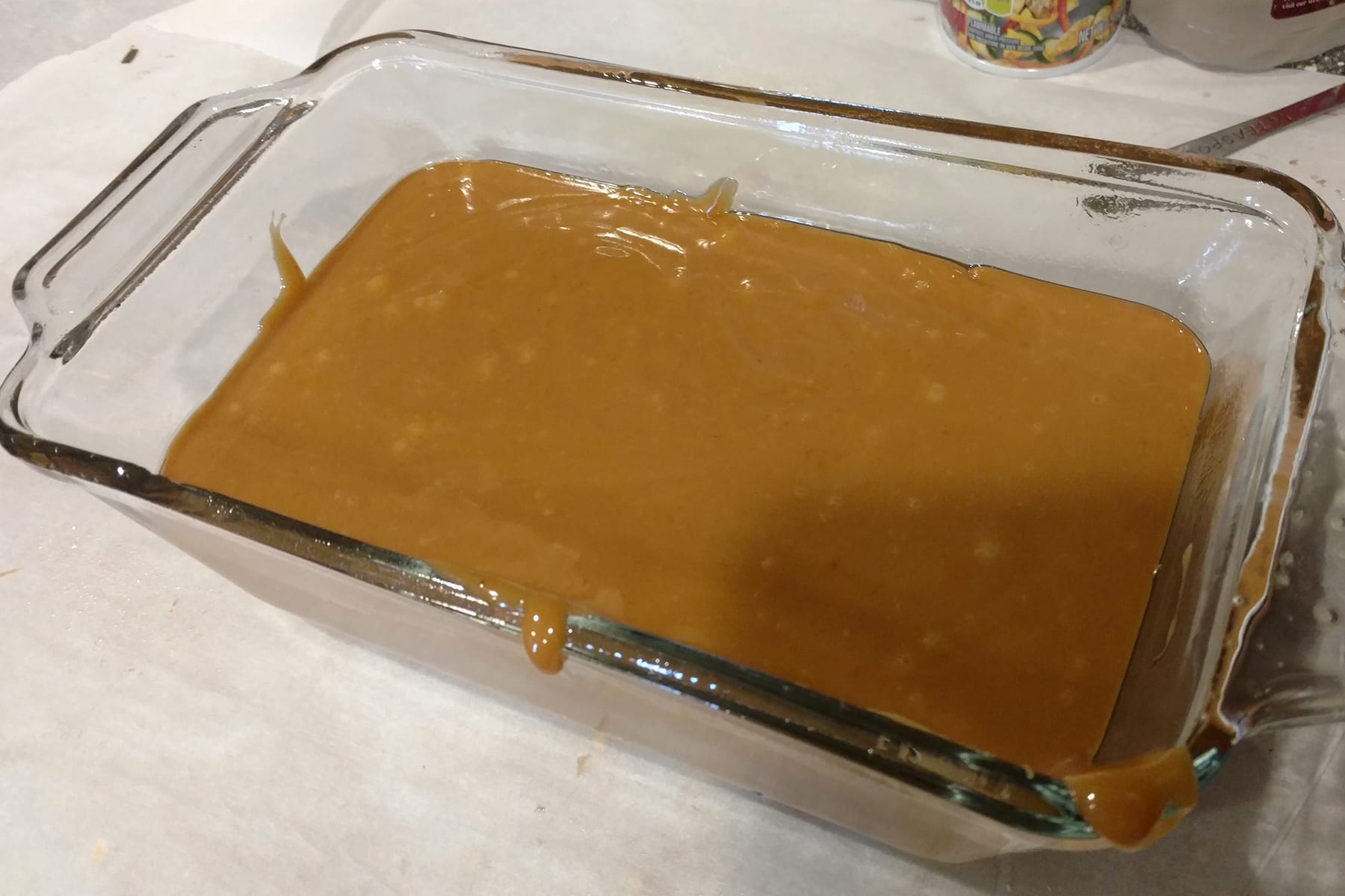 A rectangular baking dish filled with caramel.