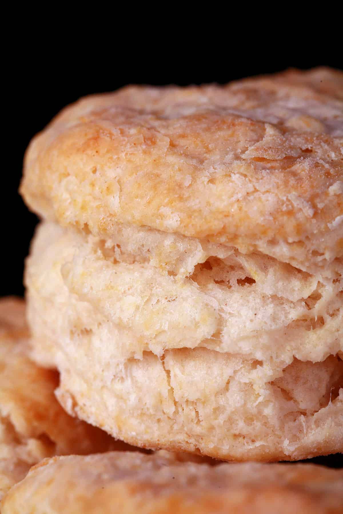 A close up view of a flaky baking powder biscuit.